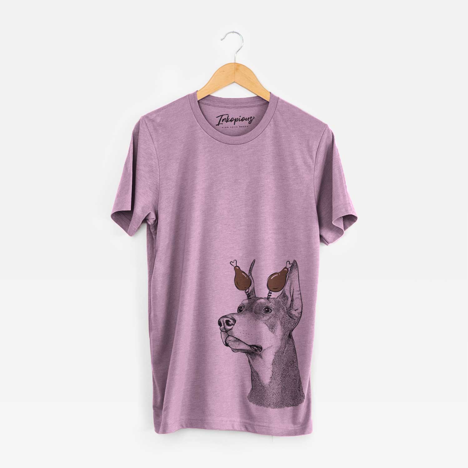 Hand-drawn sketch of Cenza the Doberman Pinscher with a Thanksgiving turkey headpiece on an Orchid Unisex crewneck