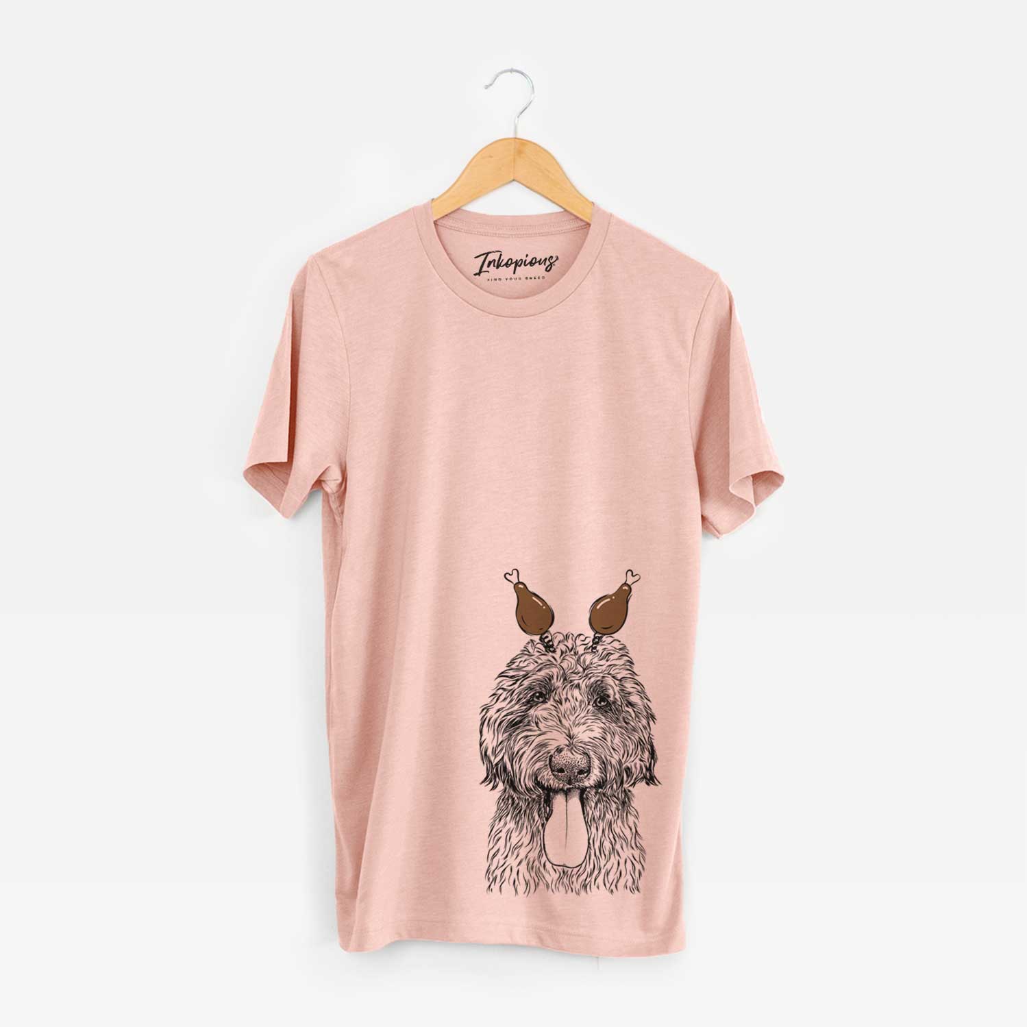 Hand-drawn sketch of CiCi Paulk the Aussiedoodle with a Thanksgiving turkey headpiece on a Peach Unisex crewneck