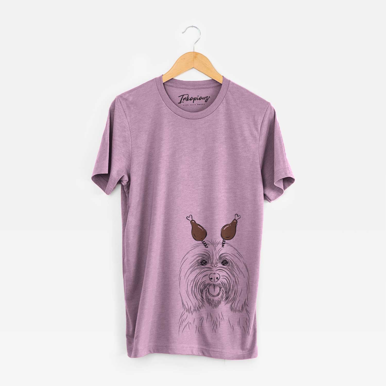 Hand-drawn sketch of Claude the Coton de Tulear with a Thanksgiving turkey headpiece on an Orchid Unisex crewneck