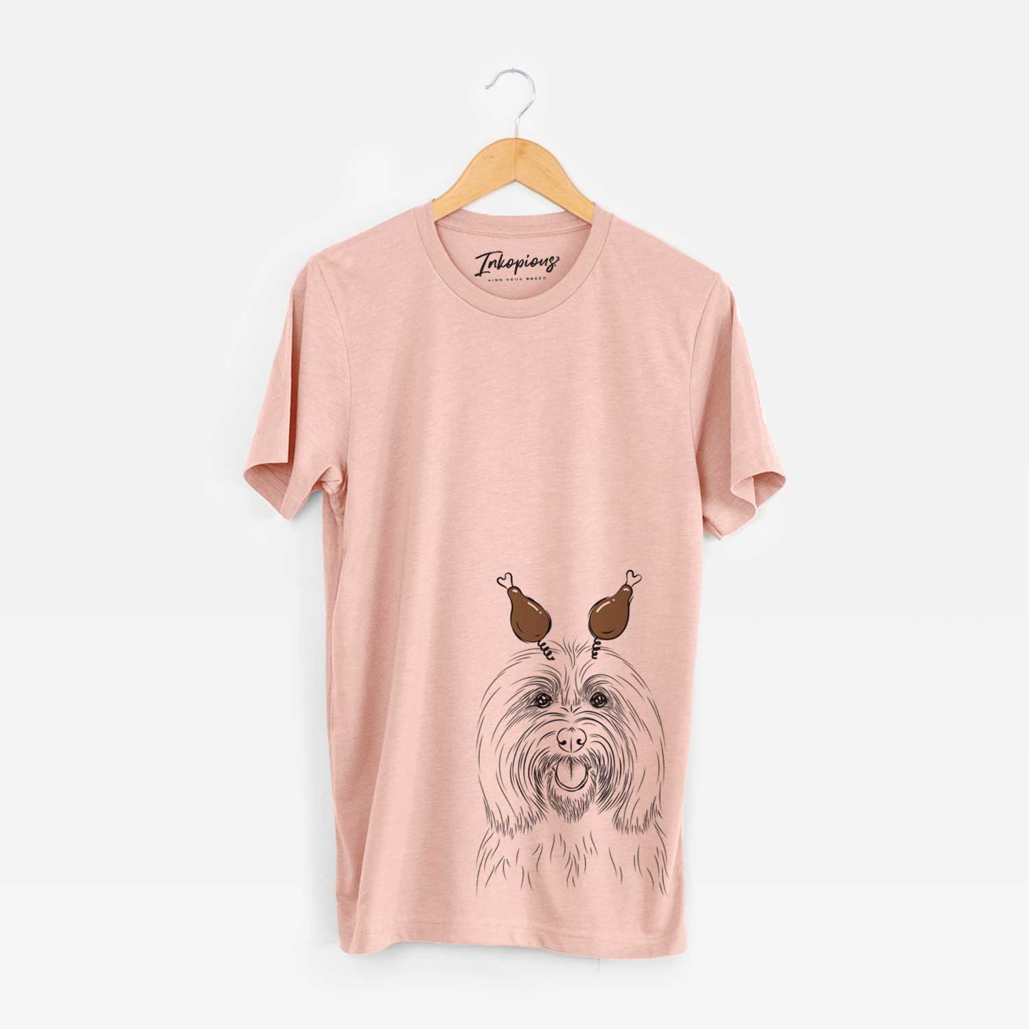 Hand-drawn sketch of Claude the Coton de Tulear with a Thanksgiving turkey headpiece on a Peach Unisex crewneck