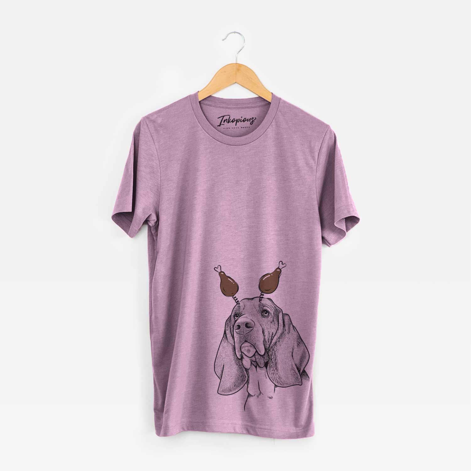Hand-drawn sketch of Cooper the Basset Hound with a Thanksgiving turkey headpiece on an Orchid Unisex crewneck