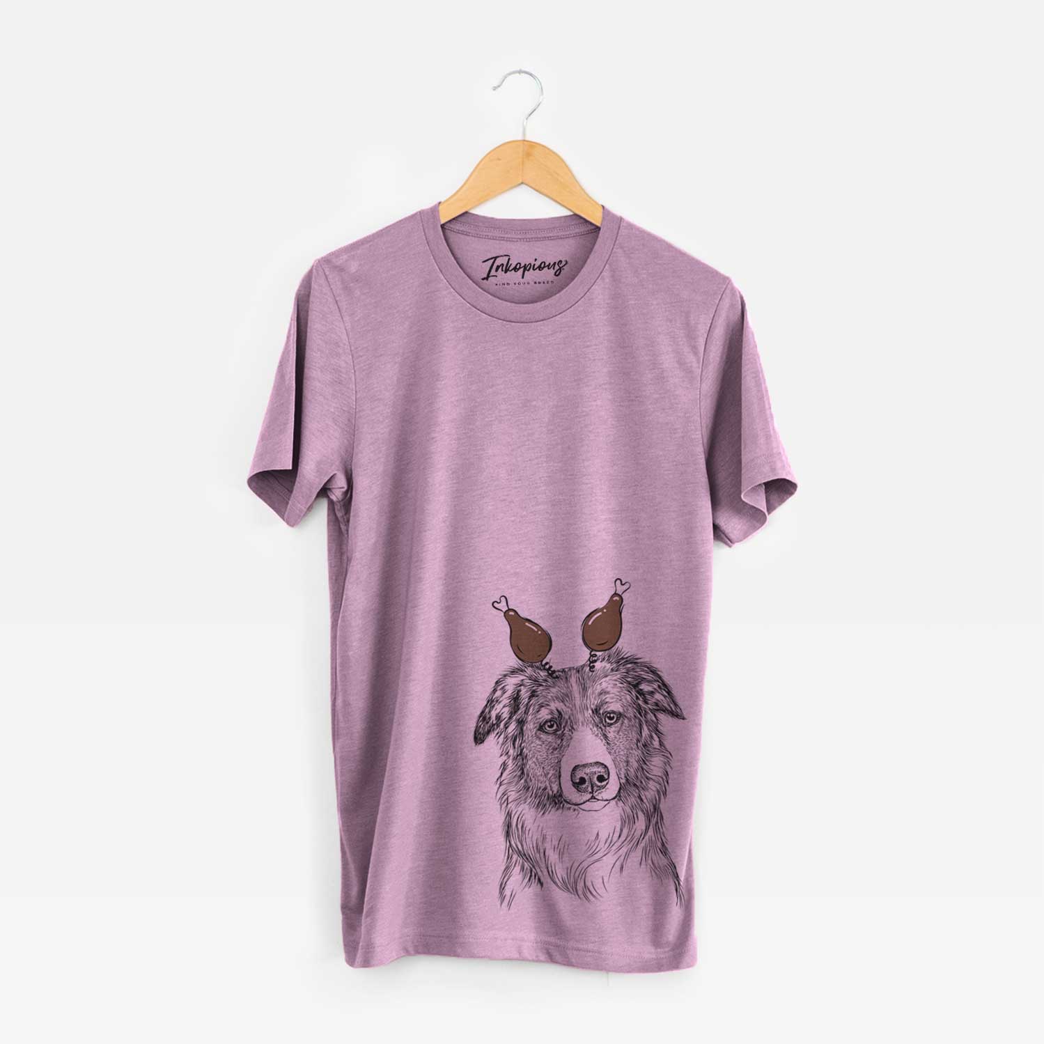 Hand-drawn sketch of Cynder the English Shepherd with a Thanksgiving turkey headpiece on an Orchid Unisex crewneck