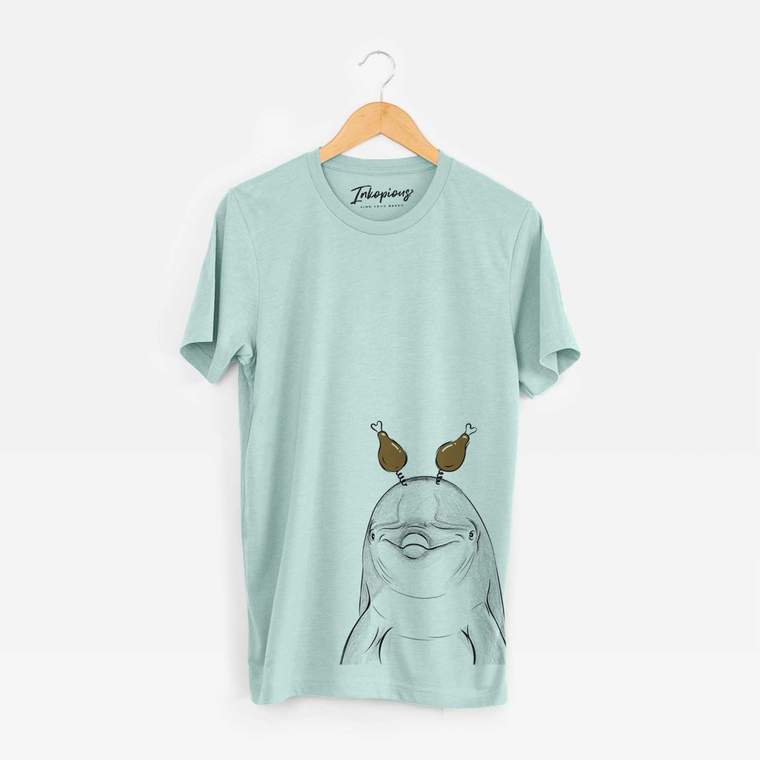 Hand-drawn sketch of Dave the Dolphin with a Thanksgiving turkey headpiece on a Heather Sage Unisex crewneck