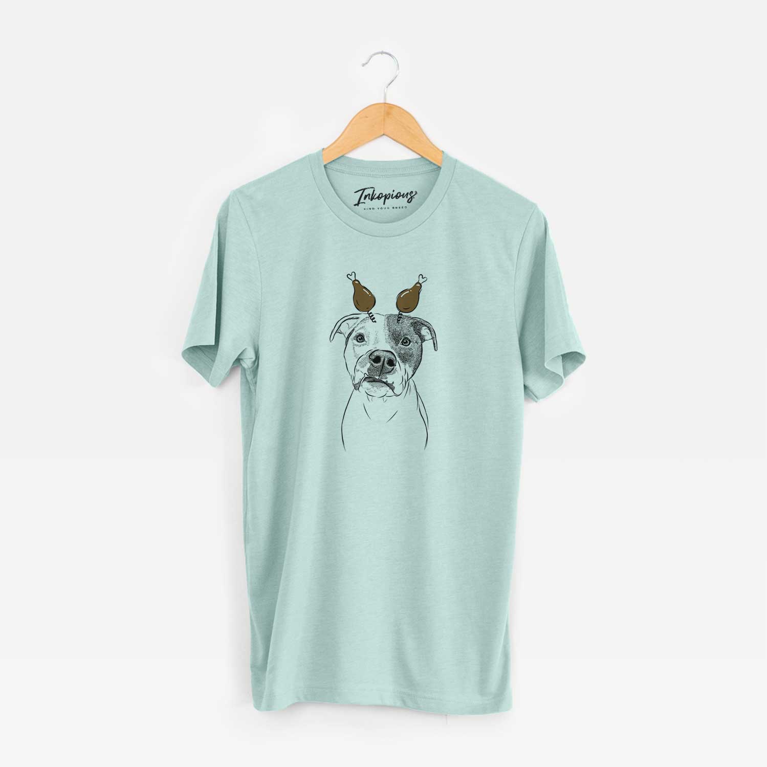 Hand-drawn sketch of Dexter the Pitbull with a Thanksgiving turkey headpiece on a Heather Sage Unisex crewneck