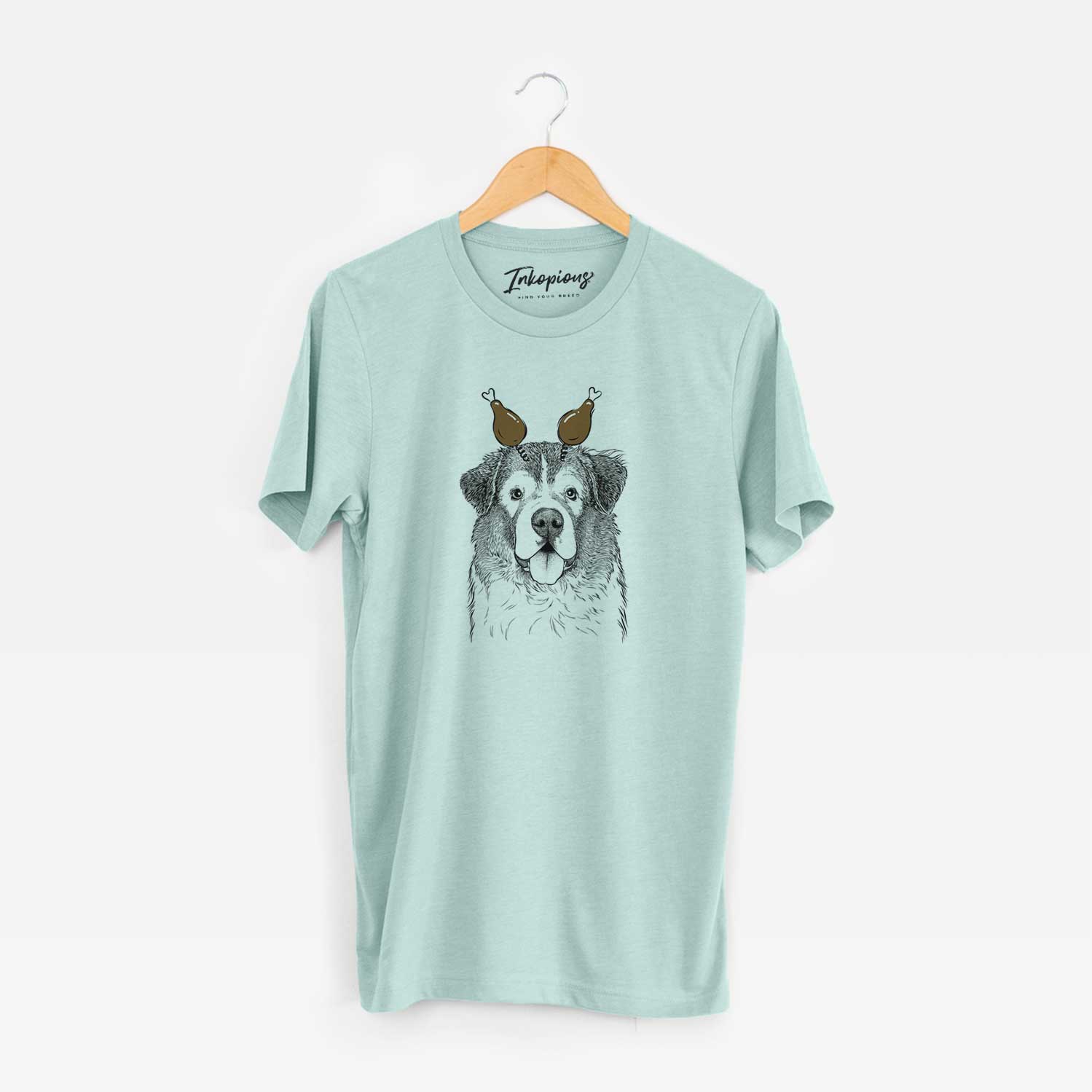 Hand-drawn sketch of Dilly the Saint Bernard with a Thanksgiving turkey headpiece on a Heather Sage Unisex crewneck