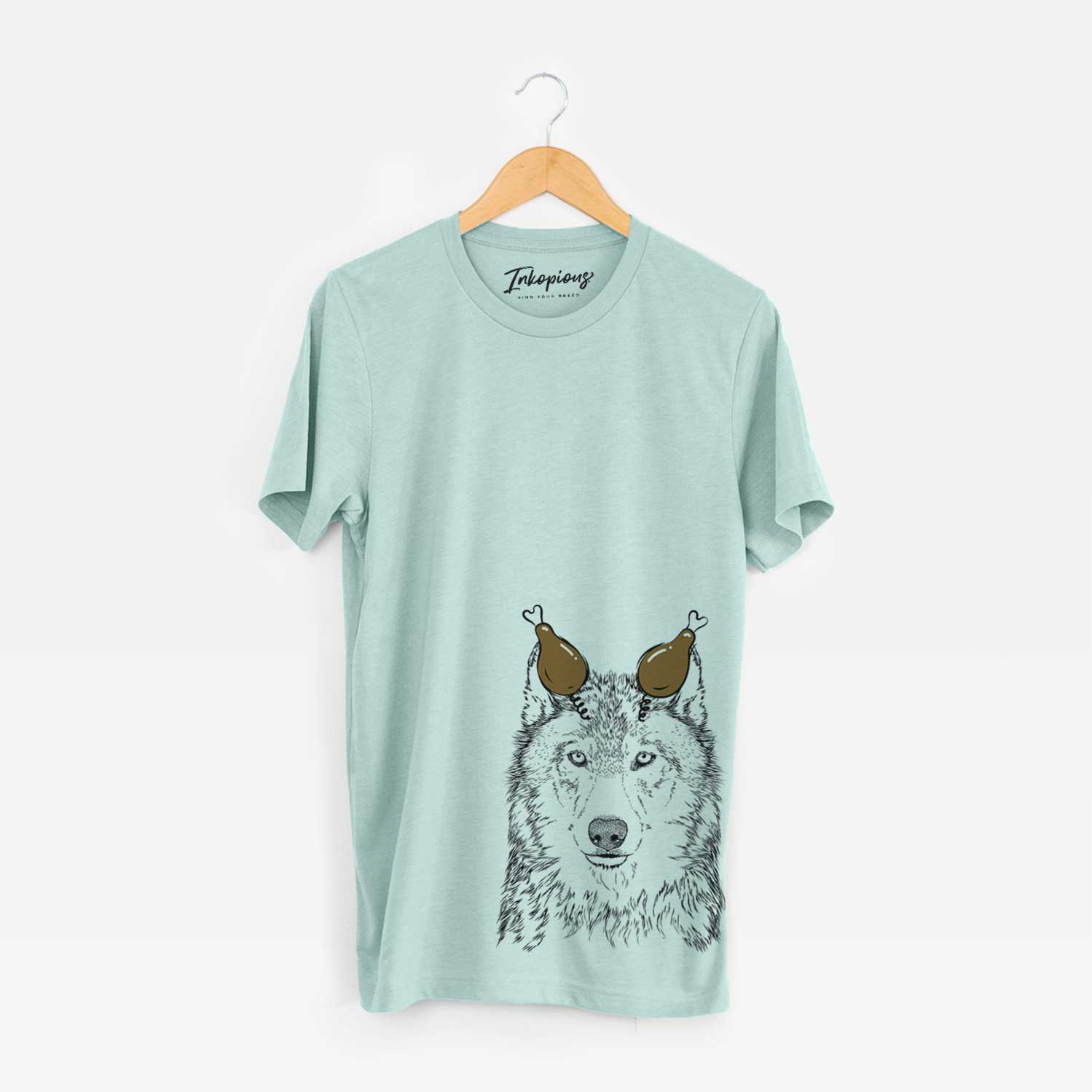 Hand-drawn sketch of Django the Grey Wolf with a Thanksgiving turkey headpiece on a Heather Sage Unisex crewneck