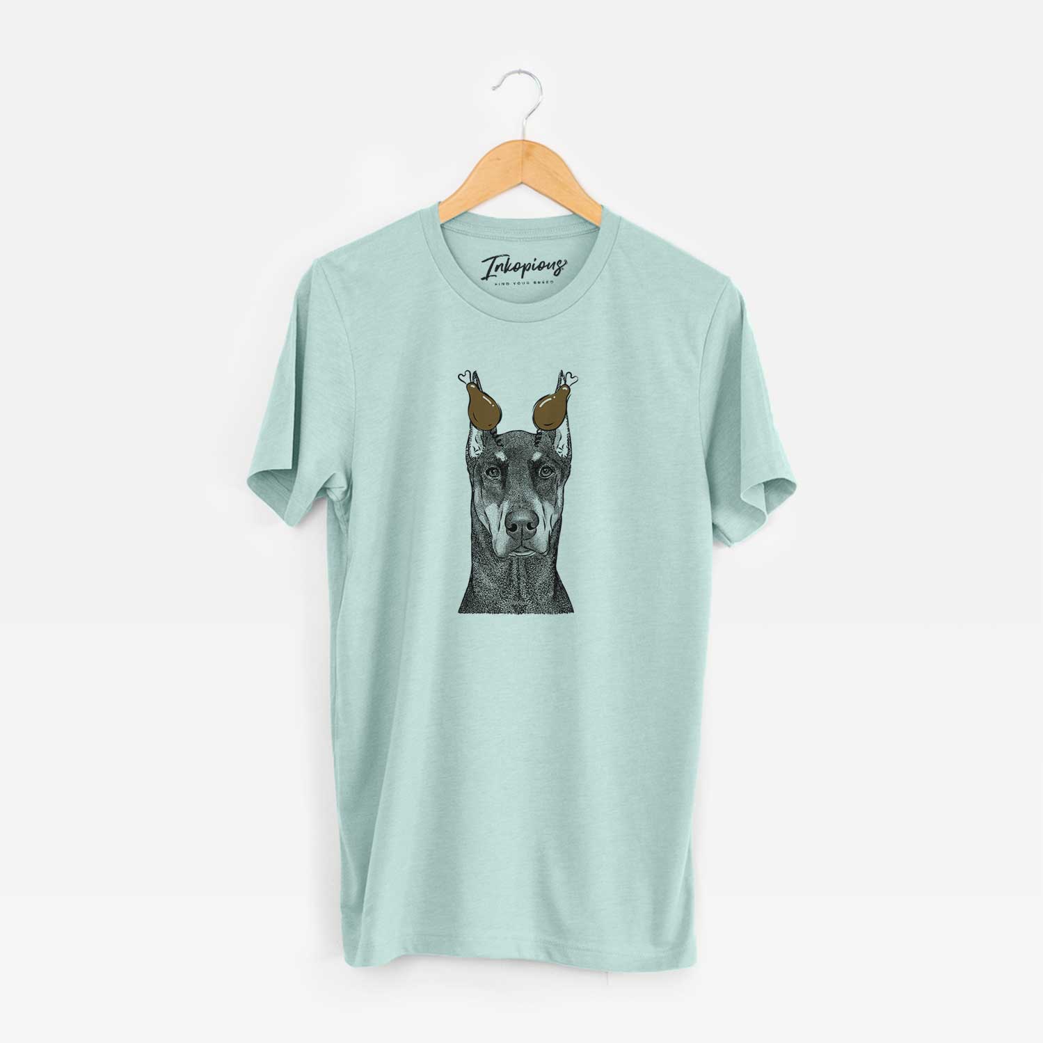 Hand-drawn sketch of Drake the Doberman Pinscher with a Thanksgiving turkey headpiece on a Heather Sage Unisex crewneck