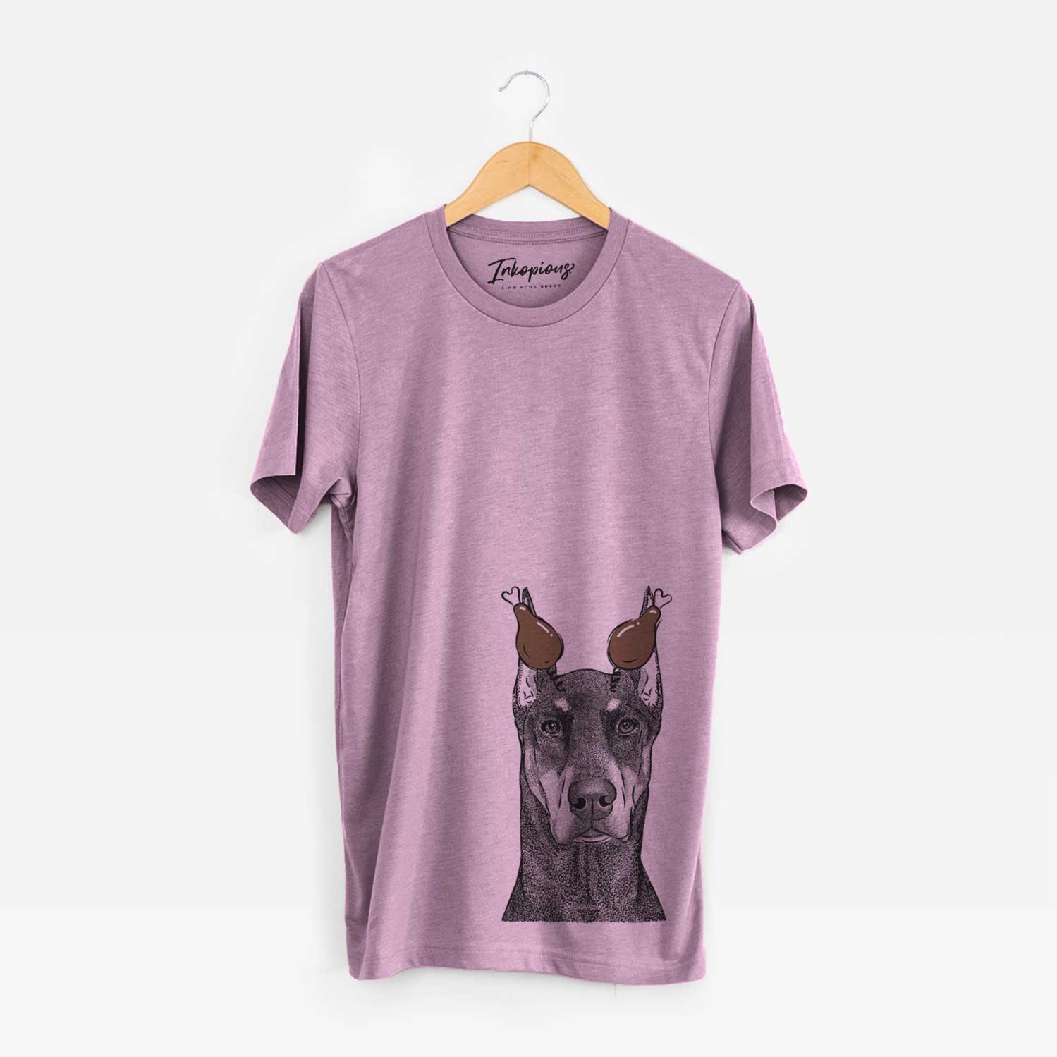 Hand-drawn sketch of Drake the Doberman Pinscher with a Thanksgiving turkey headpiece on an Orchid Unisex crewneck