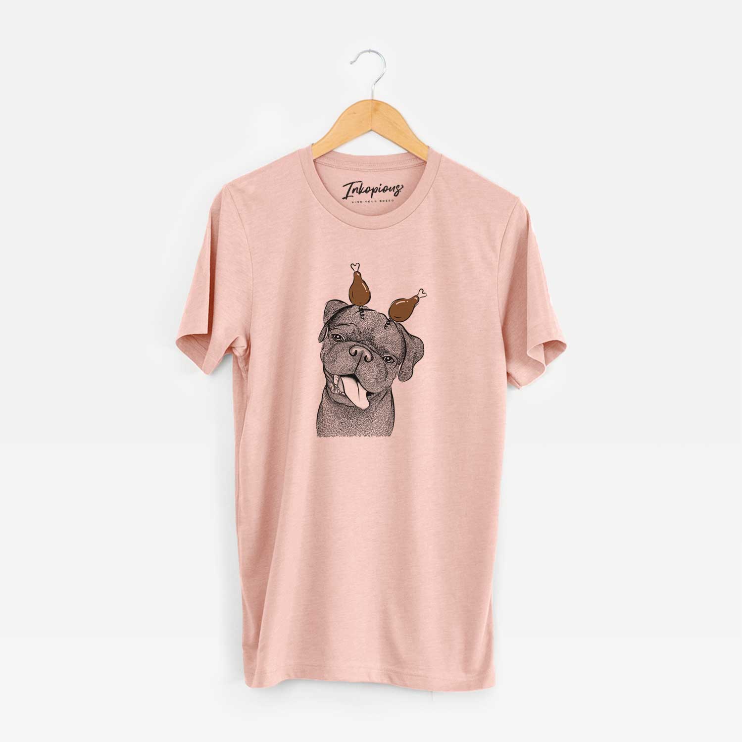 Hand-drawn sketch of Dudley Danger the Pug with a Thanksgiving turkey headpiece on a Peach Unisex crewneck