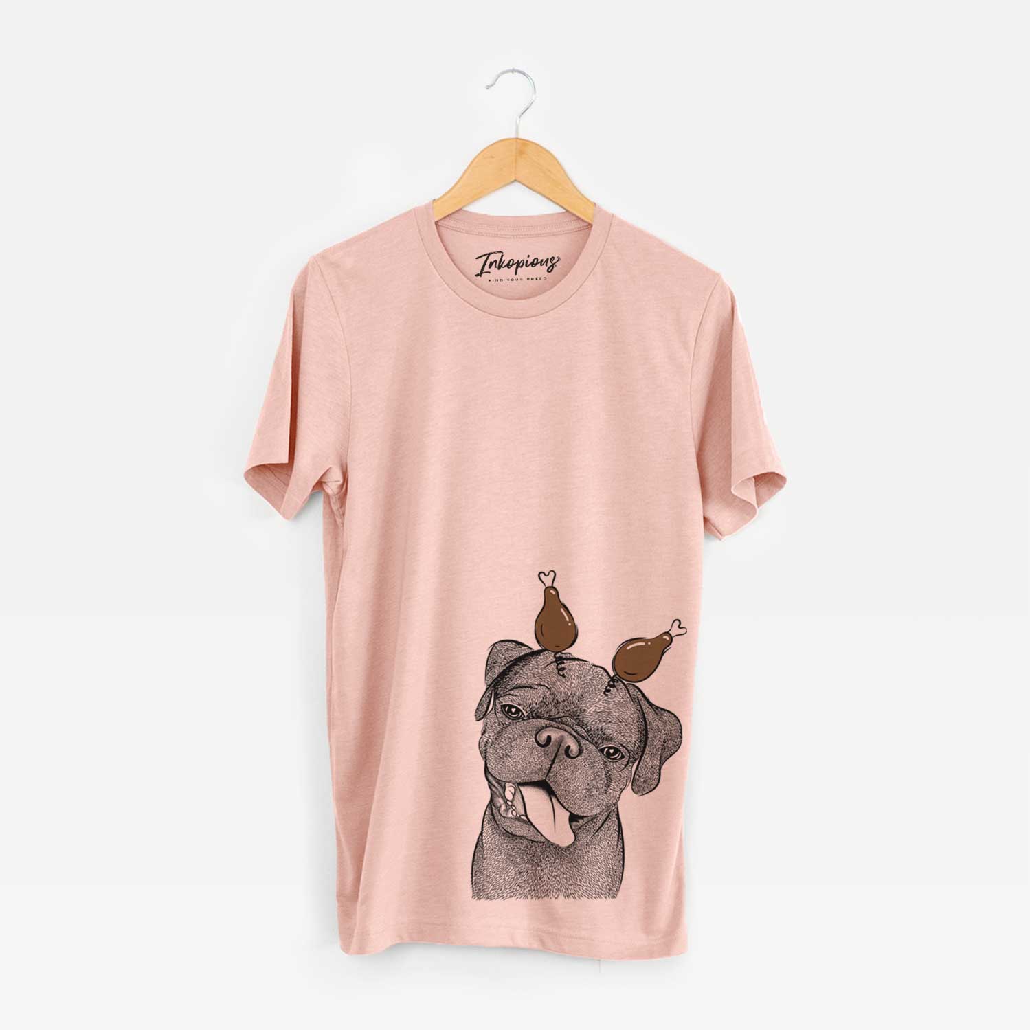 Hand-drawn sketch of Dudley Danger the Pug with a Thanksgiving turkey headpiece on a Peach Unisex crewneck