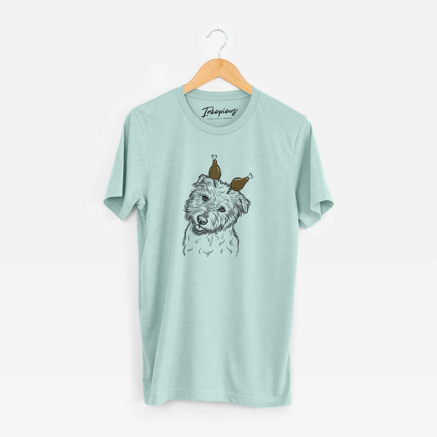 Hand-drawn sketch of Duffy the Glen of Imaal Terrier with a Thanksgiving turkey headpiece on a Heather Sage Unisex crewneck