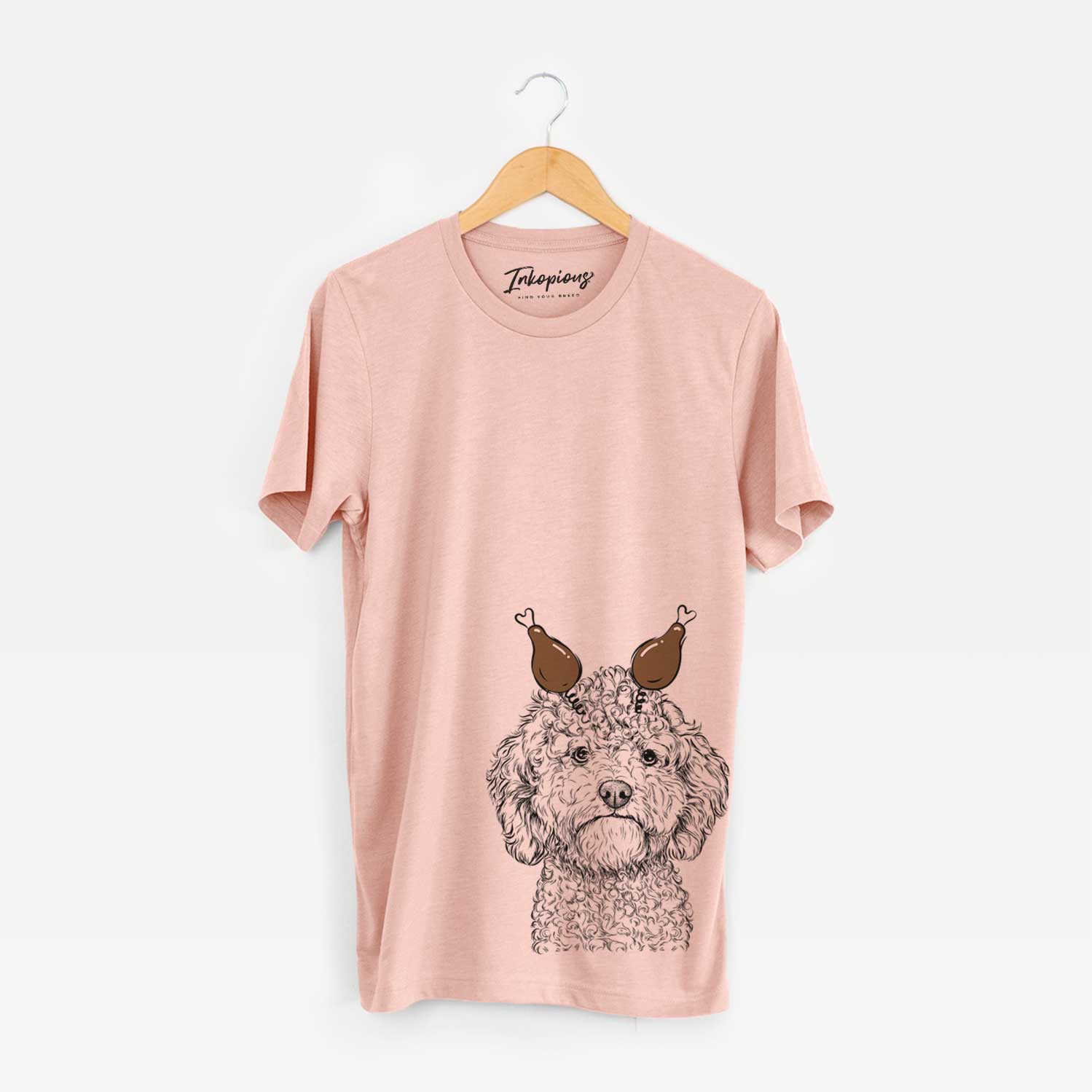 Hand-drawn sketch of Edgar the Shihpoo with a Thanksgiving turkey headpiece on a Peach Unisex crewneck