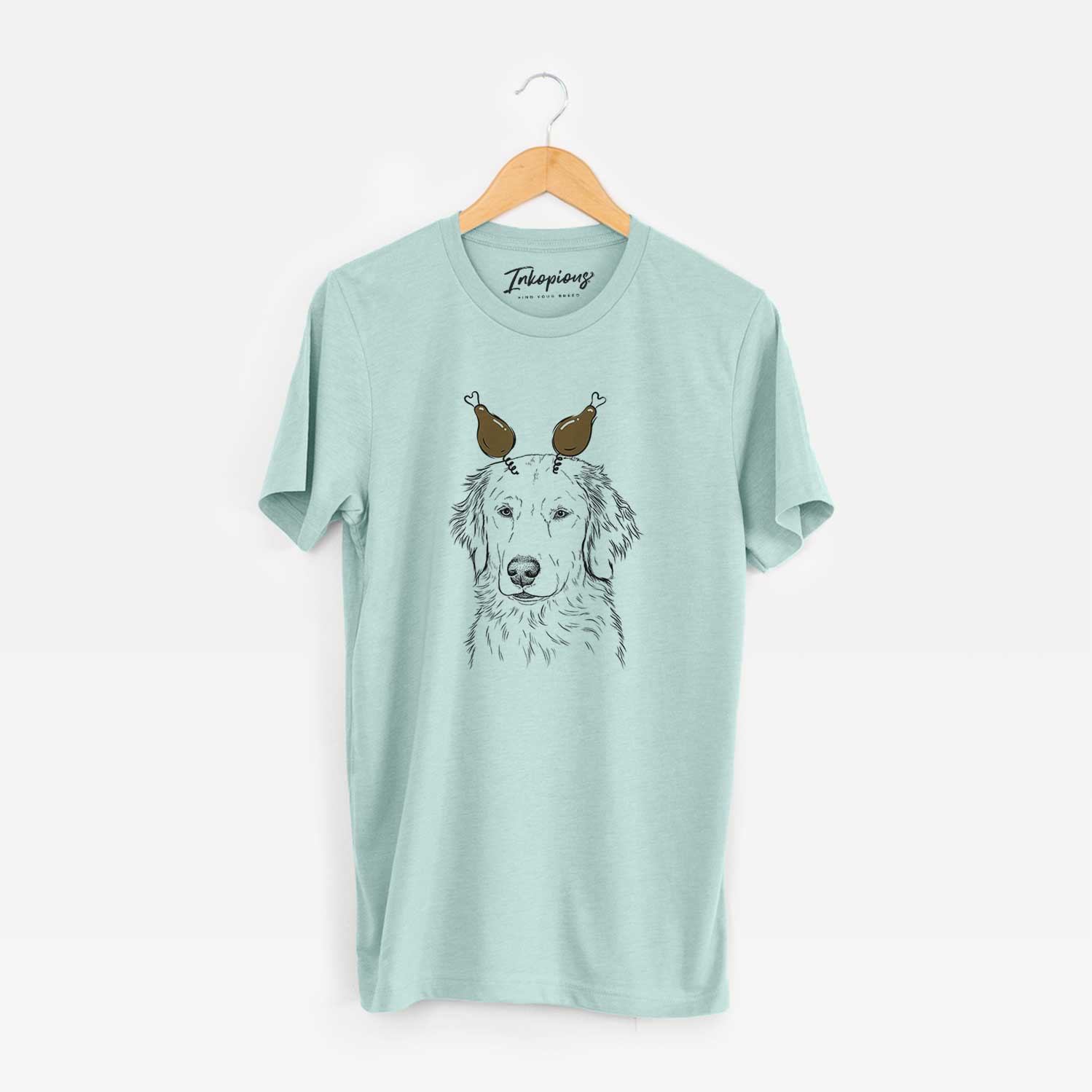 Hand-drawn sketch of Eli the Golden Retriever with a Thanksgiving turkey headpiece on a Heather Sage Unisex crewneck