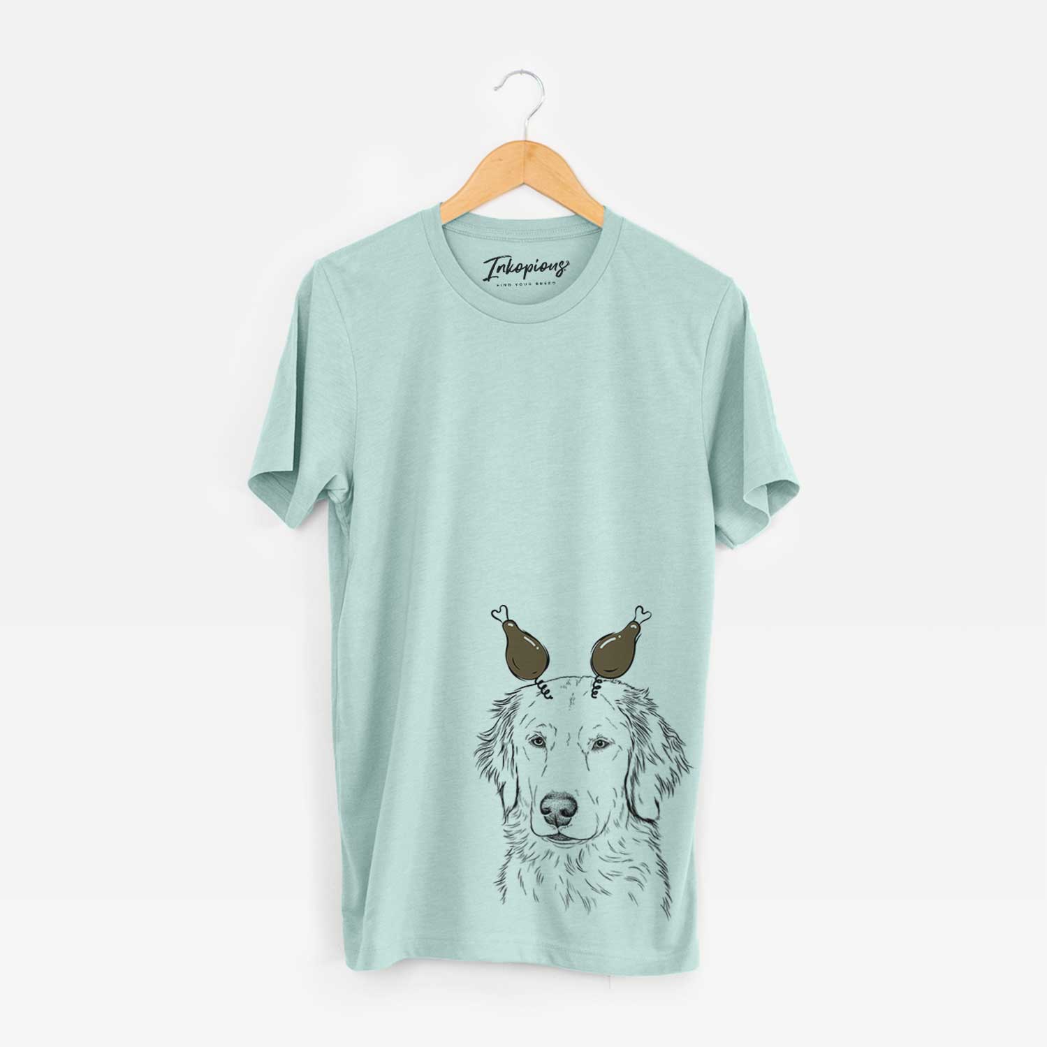 Hand-drawn sketch of Eli the Golden Retriever with a Thanksgiving turkey headpiece on a Heather Sage Unisex crewneck