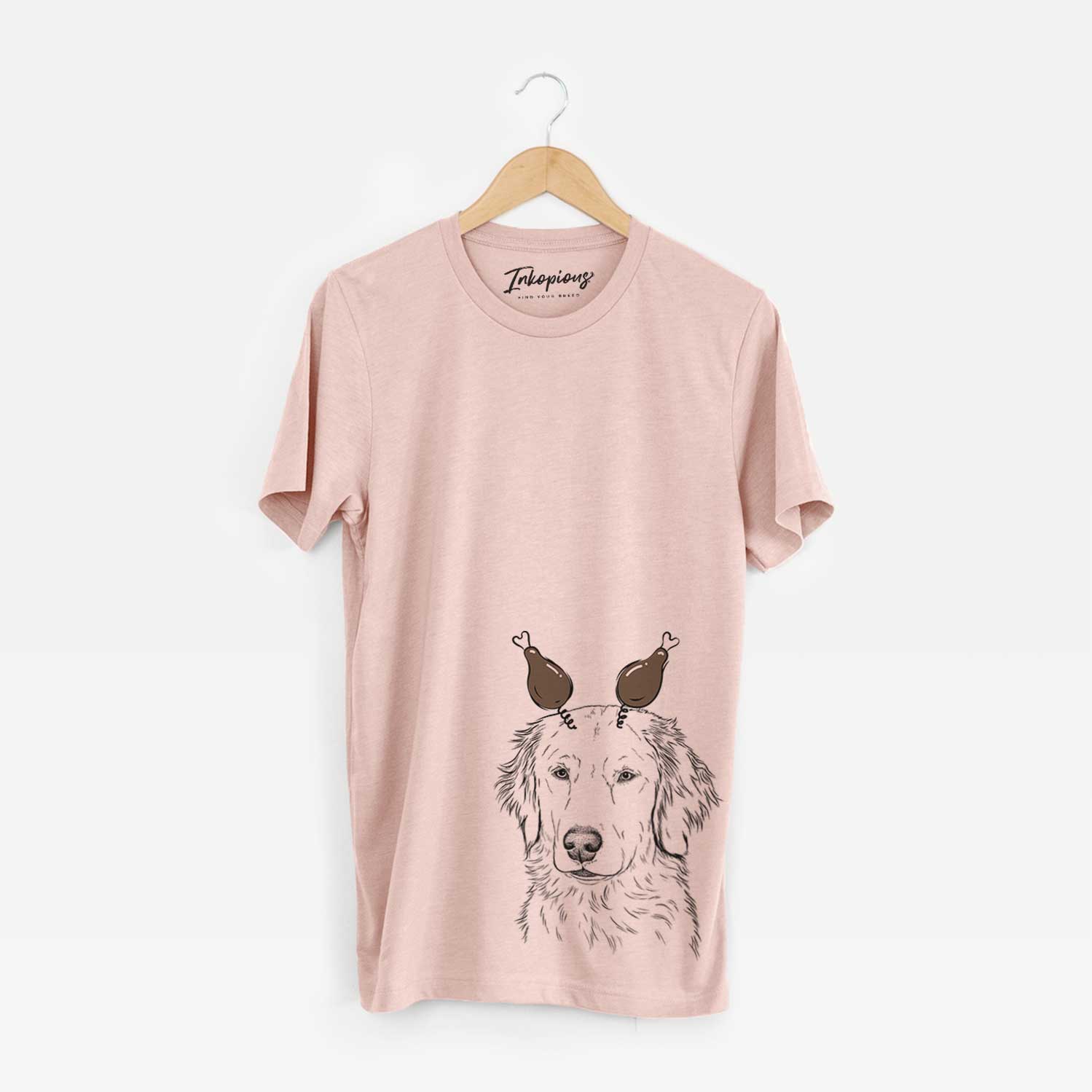Hand-drawn sketch of Eli the Golden Retriever with a Thanksgiving turkey headpiece on a Peach Unisex crewneck