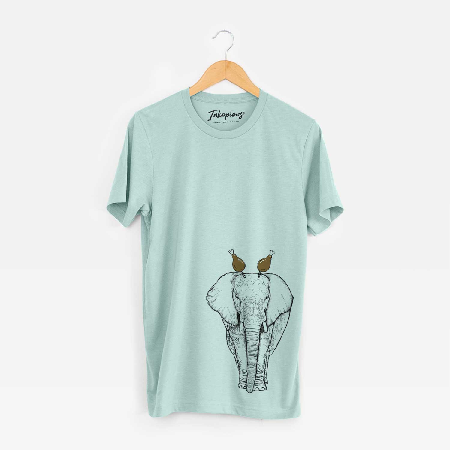 Hand-drawn sketch of Ella the Elephant with a Thanksgiving turkey headpiece on a Heather Sage Unisex crewneck