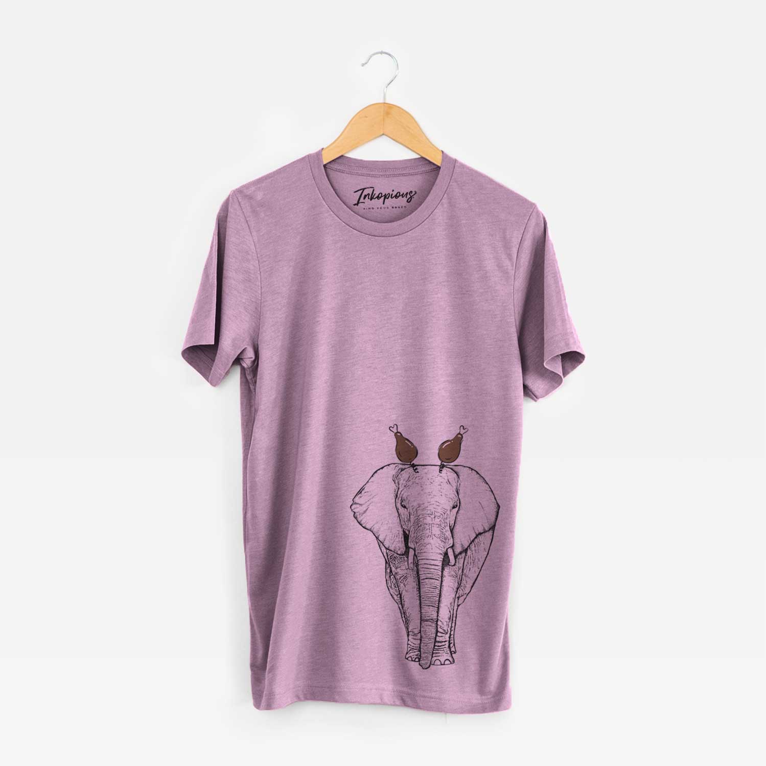 Hand-drawn sketch of Ella the Elephant with a Thanksgiving turkey headpiece on an Orchid Unisex crewneck