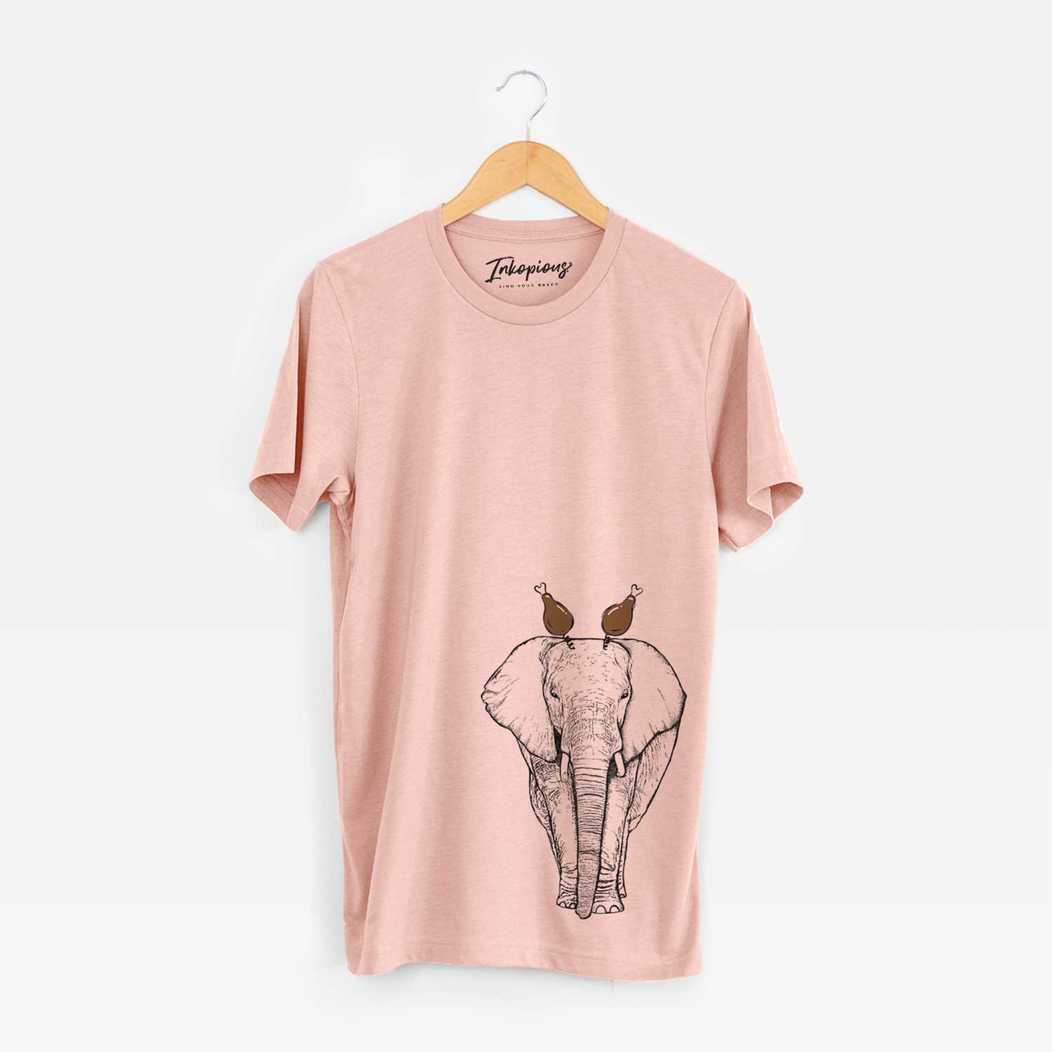 Hand-drawn sketch of Ella the Elephant with a Thanksgiving turkey headpiece on a Peach Unisex crewneck
