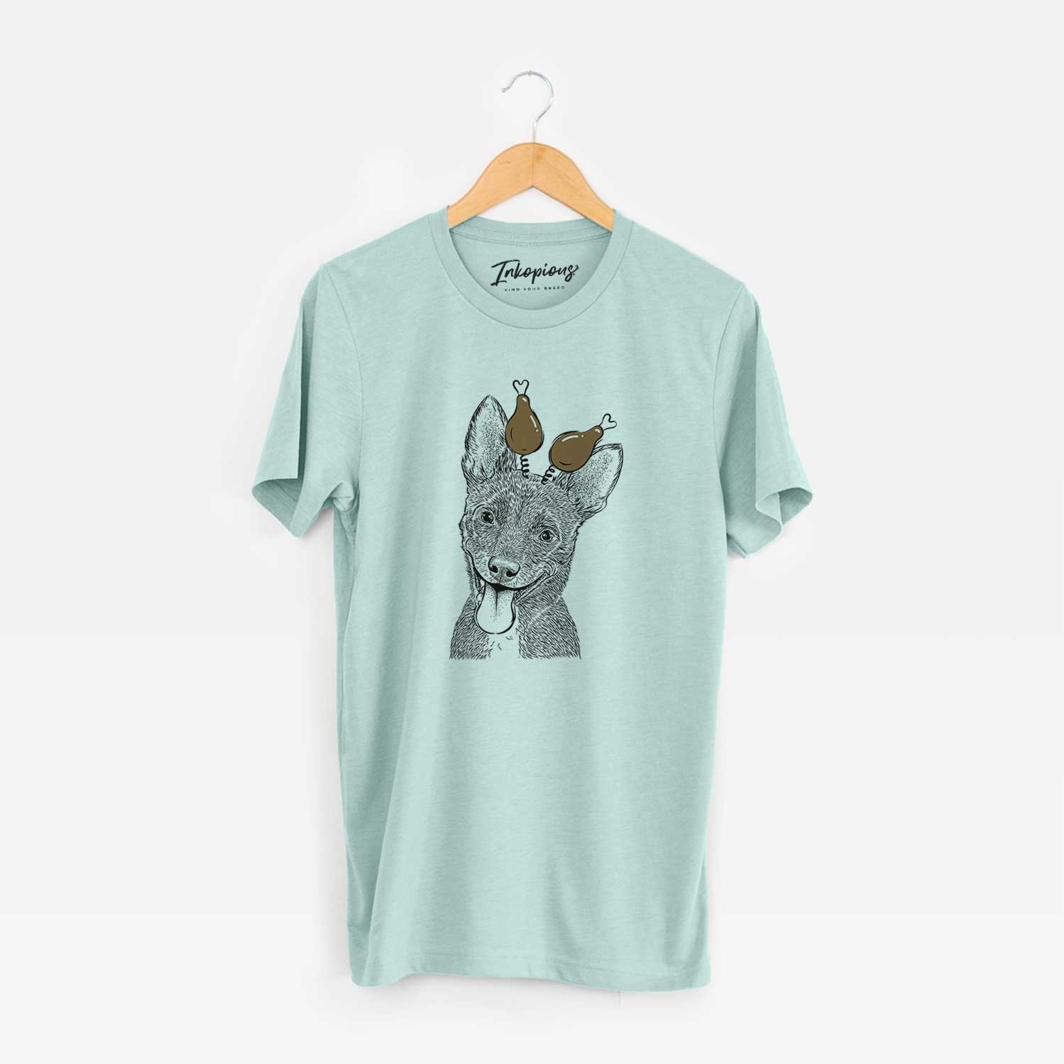 Hand-drawn sketch of Elvira the Terrier Mix with a Thanksgiving turkey headpiece on a Heather Sage Unisex crewneck