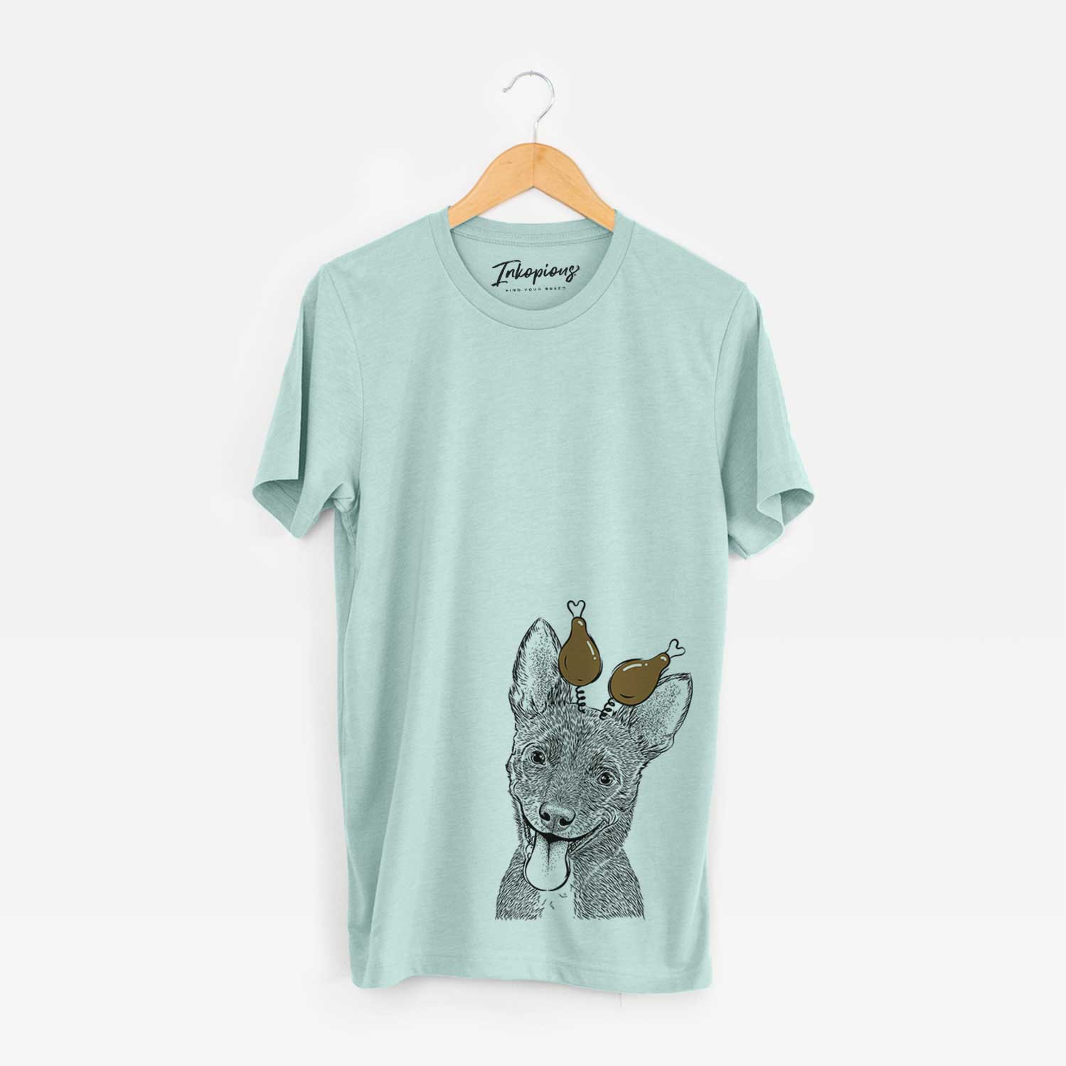 Hand-drawn sketch of Elvira the Terrier Mix with a Thanksgiving turkey headpiece on a Heather Sage Unisex crewneck