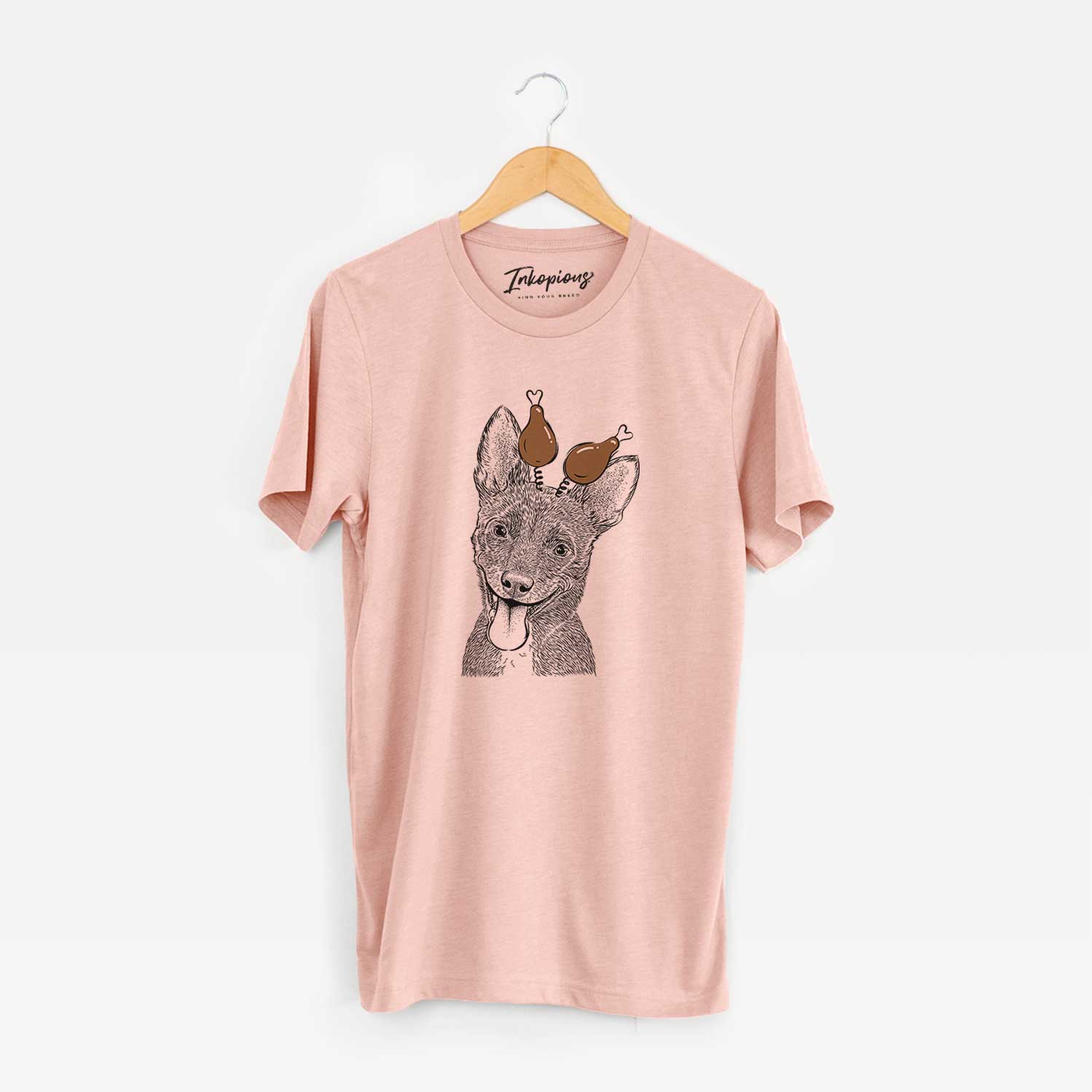 Hand-drawn sketch of Elvira the Terrier Mix with a Thanksgiving turkey headpiece on a Peach Unisex crewneck