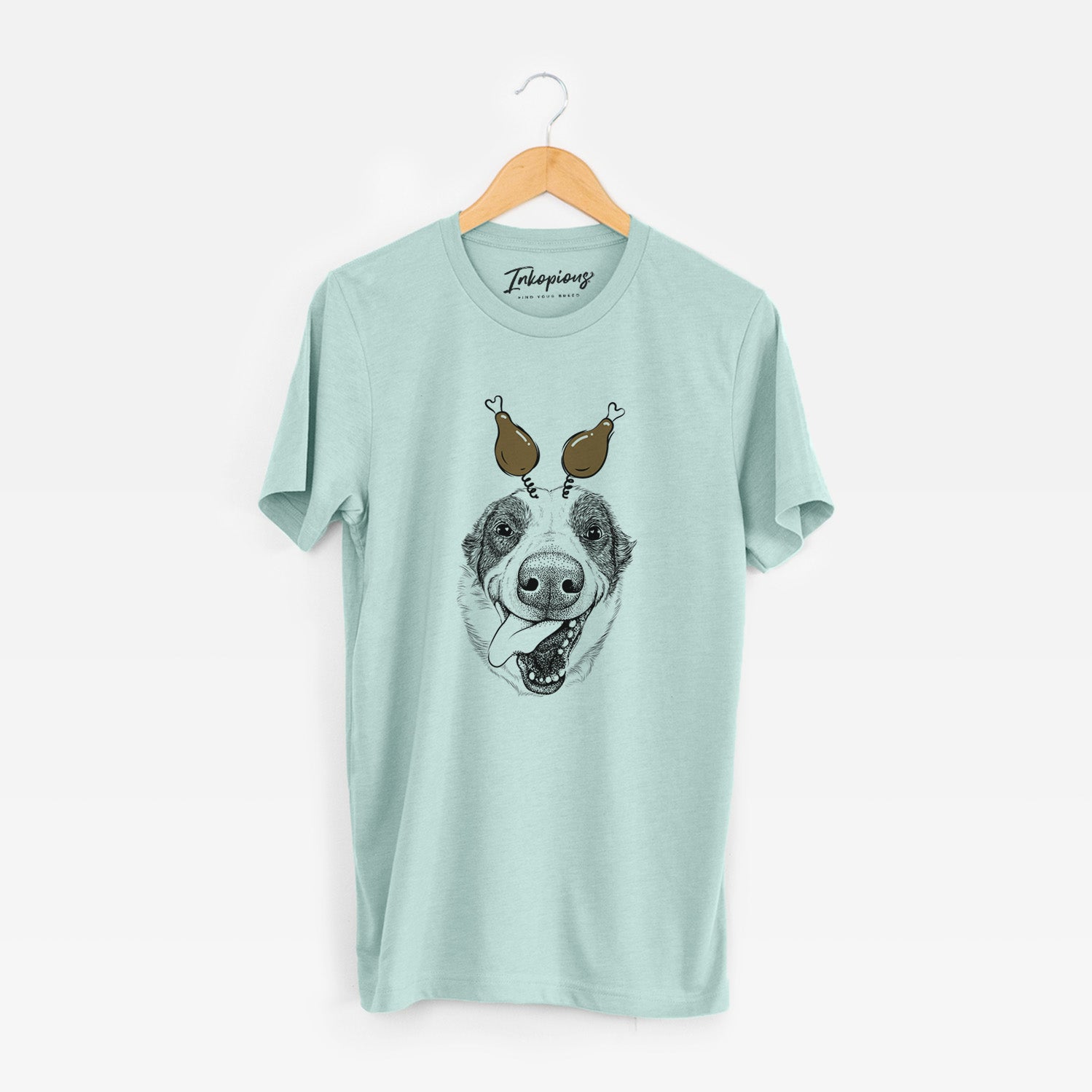 Hand-drawn sketch of Elwood the Border Collie with a Thanksgiving turkey headpiece on a Heather Sage Unisex crewneck