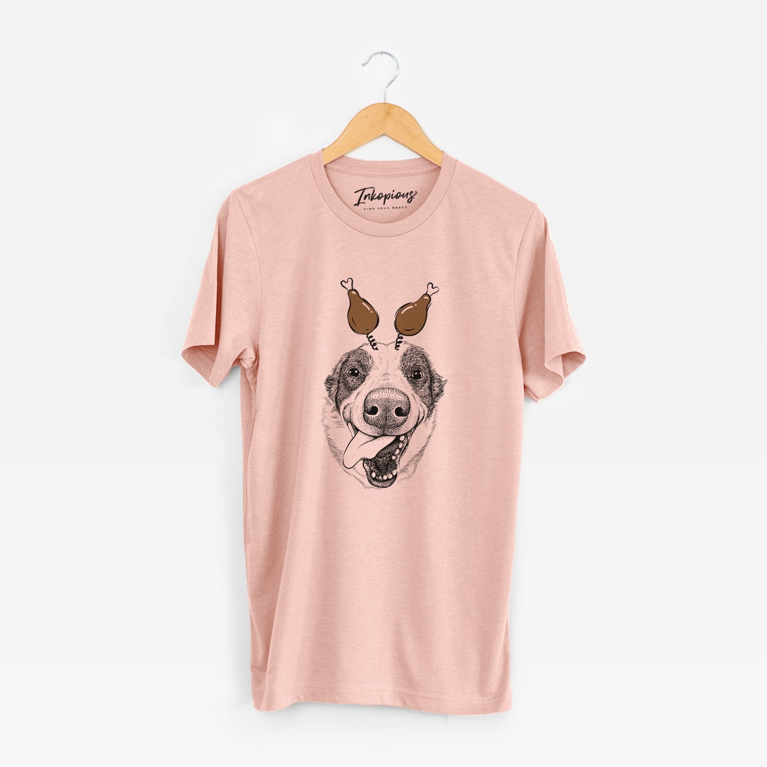 Hand-drawn sketch of Elwood the Border Collie with a Thanksgiving turkey headpiece on a Peach Unisex crewneck