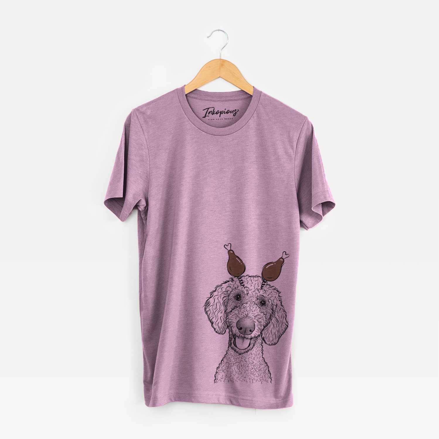 Hand-drawn sketch of Fenway the Goldendoodle with a Thanksgiving turkey headpiece on an Orchid Unisex crewneck