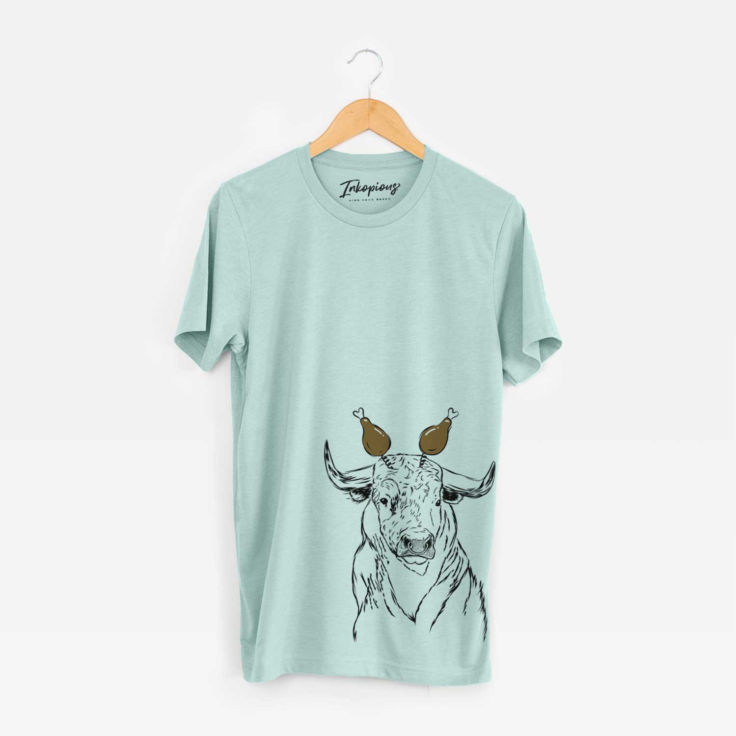 Hand-drawn sketch of Ferdinand the Bull with a Thanksgiving turkey headpiece on a Heather Sage Unisex crewneck
