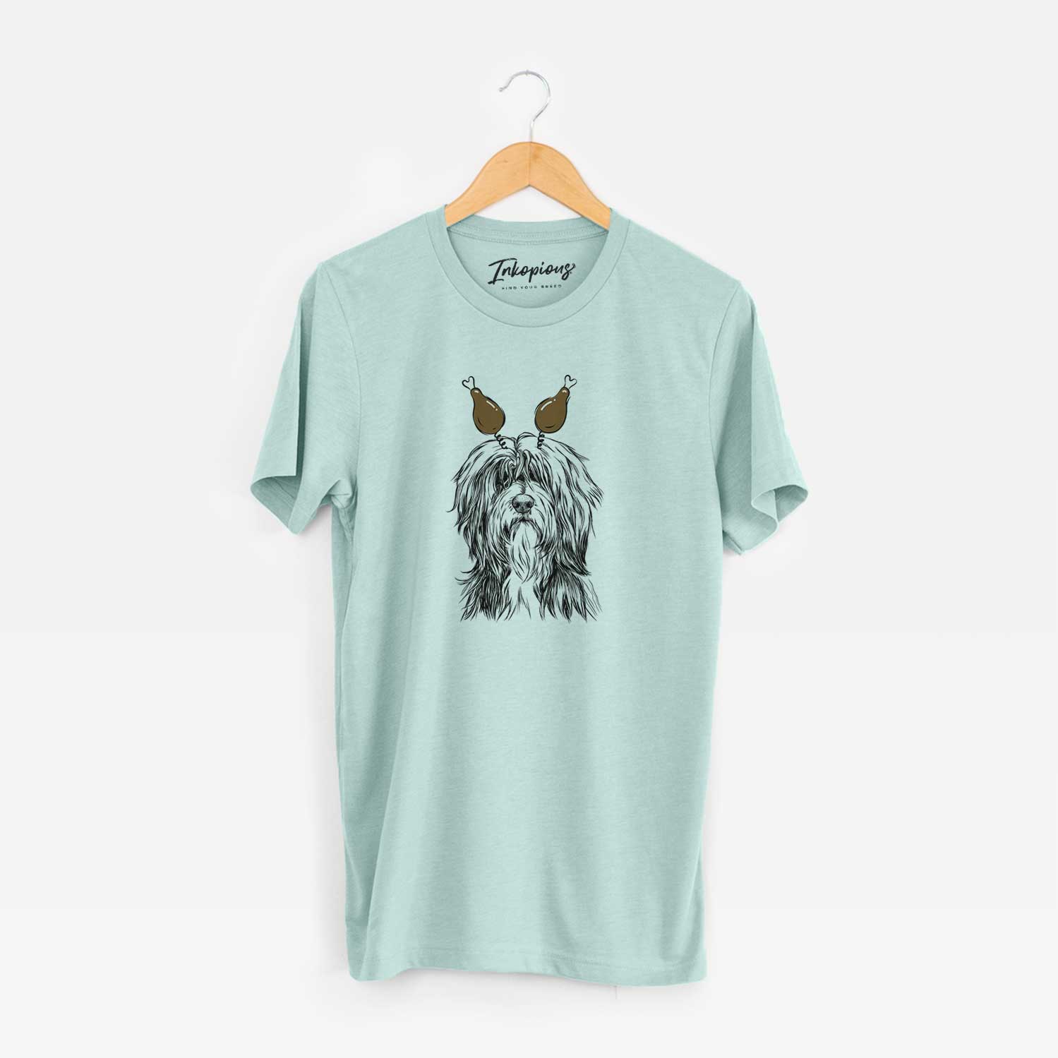 Hand-drawn sketch of Fiji the Polish Lowland Sheepdog with a Thanksgiving turkey headpiece on a Heather Sage Unisex crewneck