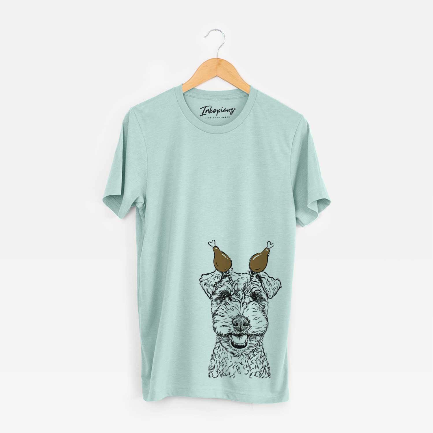 Hand-drawn sketch of Fintan the Irish Troodle with a Thanksgiving turkey headpiece on a Heather Sage Unisex crewneck