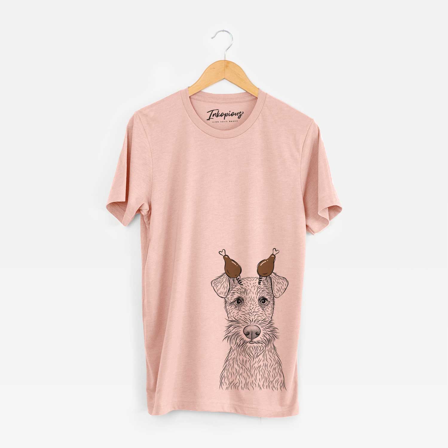 Hand-drawn sketch of Fitz the Wire Fox Terrier with a Thanksgiving turkey headpiece on a Peach Unisex crewneck