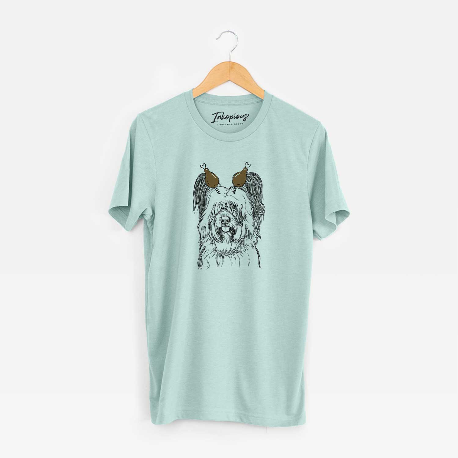 Hand-drawn sketch of Gideon the Skye Terrier with a Thanksgiving turkey headpiece on a Heather Sage Unisex crewneck