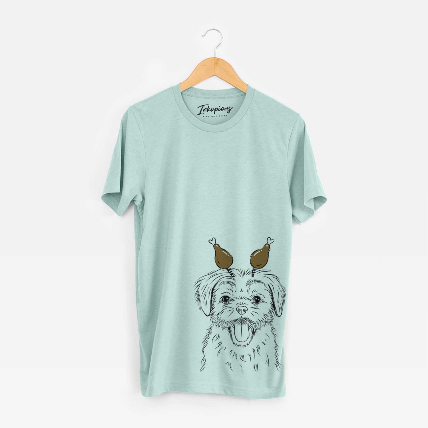 Hand-drawn sketch of Gizmo the Maltese with a Thanksgiving turkey headpiece on a Heather Sage Unisex crewneck