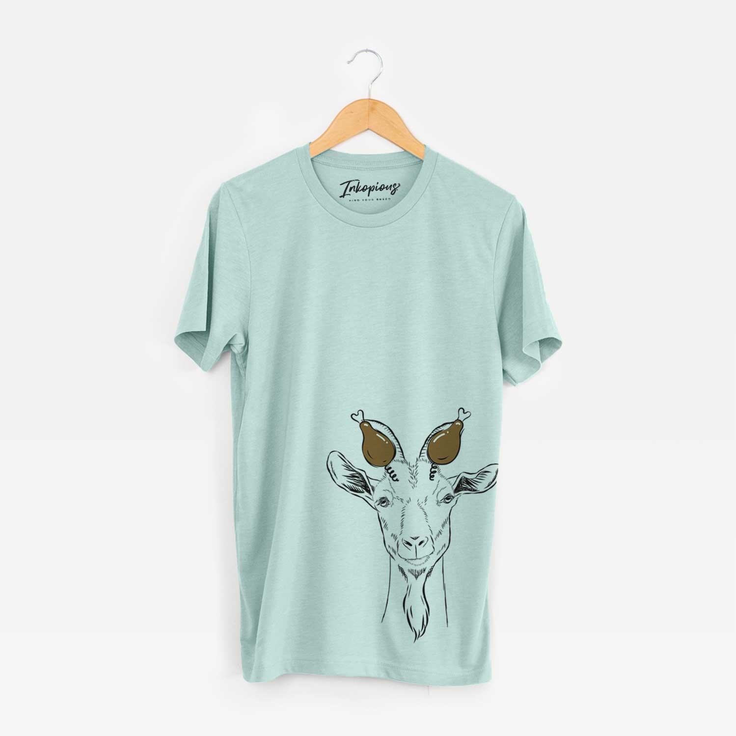 Hand-drawn sketch of Gunnar the Goat with a Thanksgiving turkey headpiece on a Heather Sage Unisex crewneck