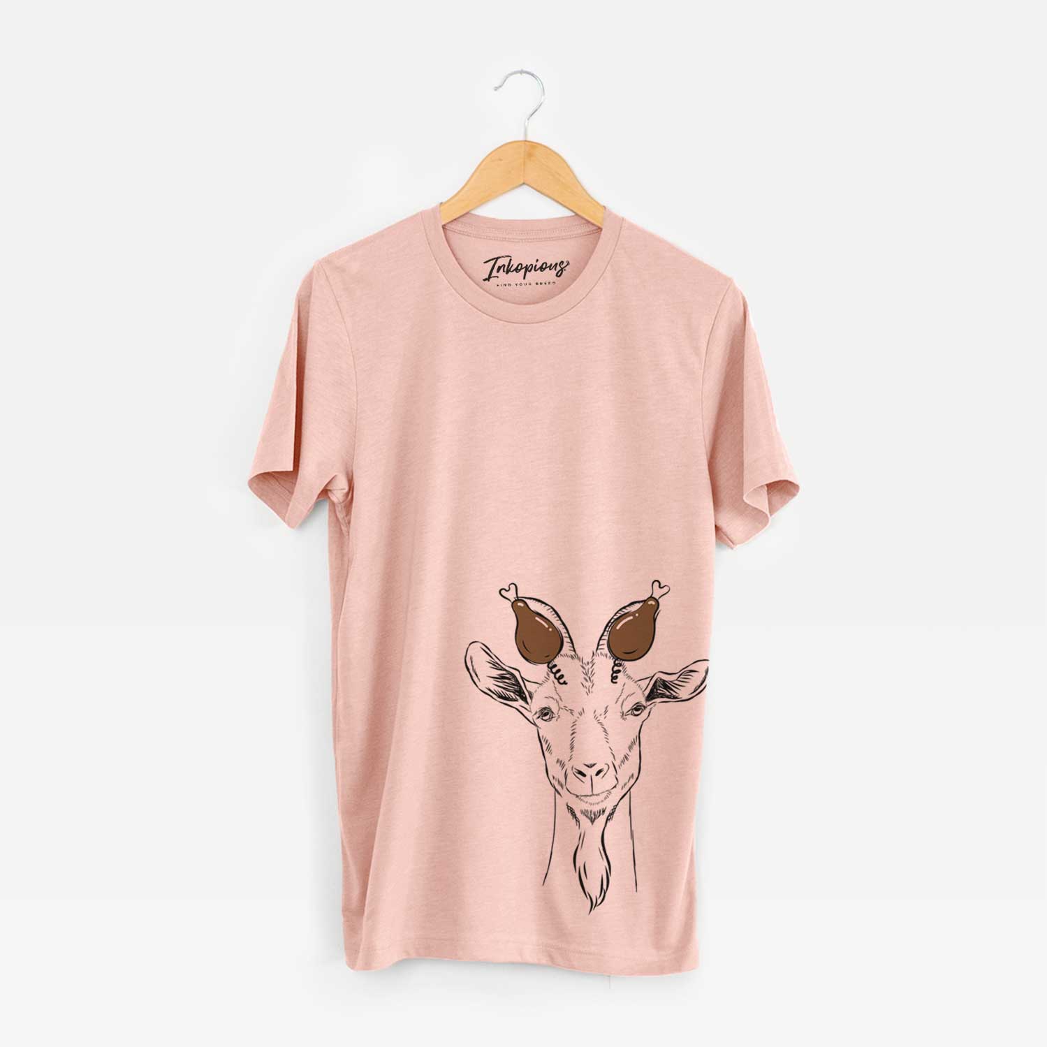 Hand-drawn sketch of Gunnar the Goat with a Thanksgiving turkey headpiece on a Peach Unisex crewneck