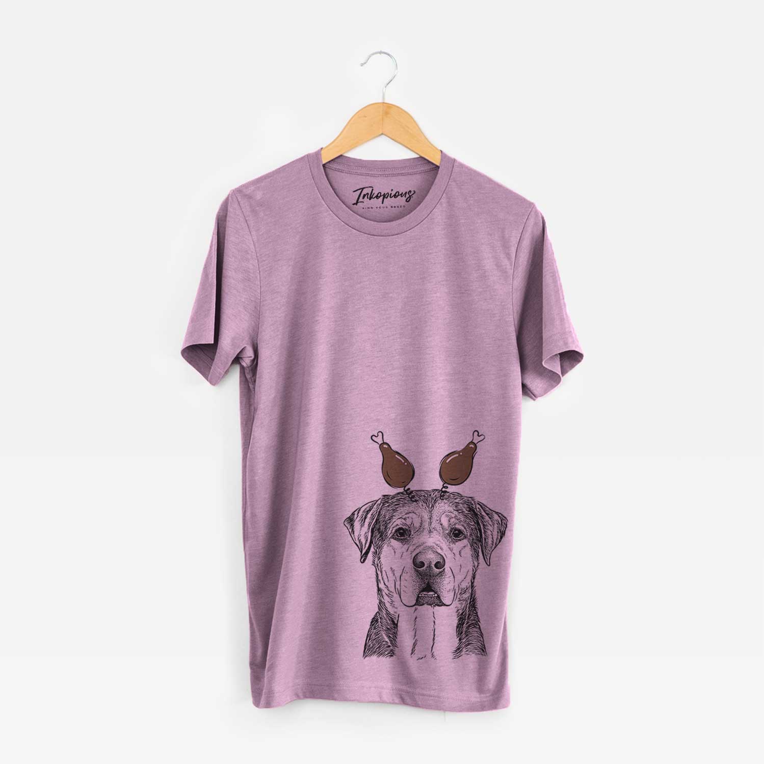 Hand-drawn sketch of Gus the Rottweiler Mix with a Thanksgiving turkey headpiece on an Orchid Unisex crewneck