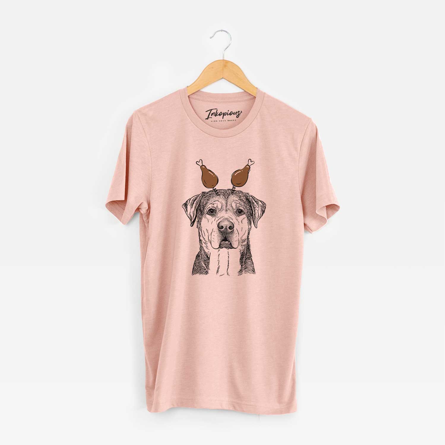 Hand-drawn sketch of Gus the Rottweiler Mix with a Thanksgiving turkey headpiece on a Peach Unisex crewneck