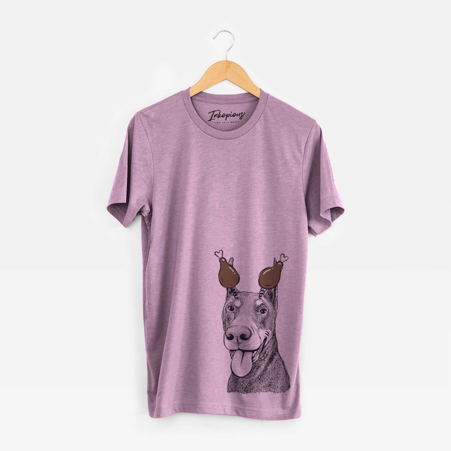 Hand-drawn sketch of Happy Sunny the Doberman Pinscher with a Thanksgiving turkey headpiece on an Orchid Unisex crewneck