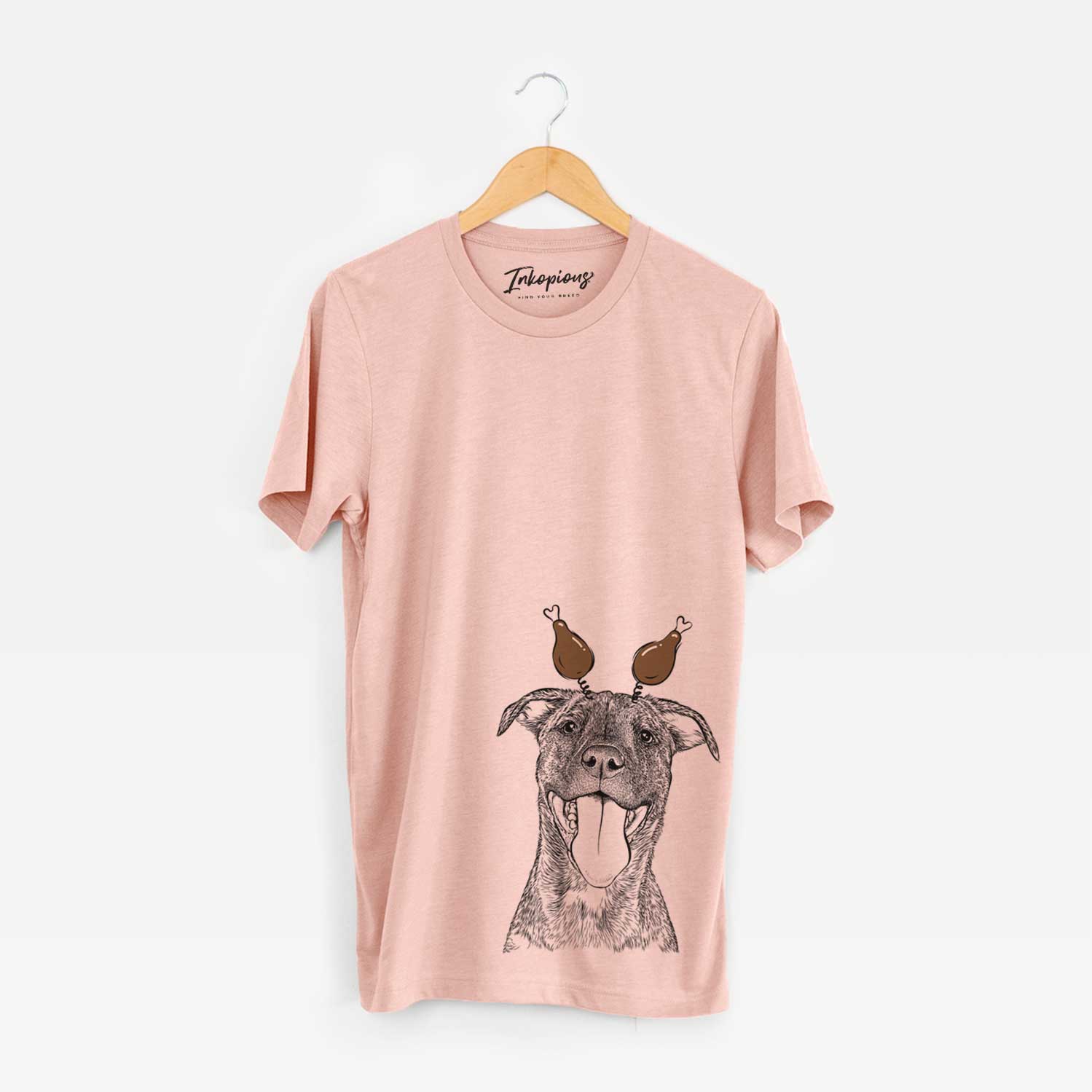 Hand-drawn sketch of Harley the Pitbull Mix with a Thanksgiving turkey headpiece on a Peach Unisex crewneck