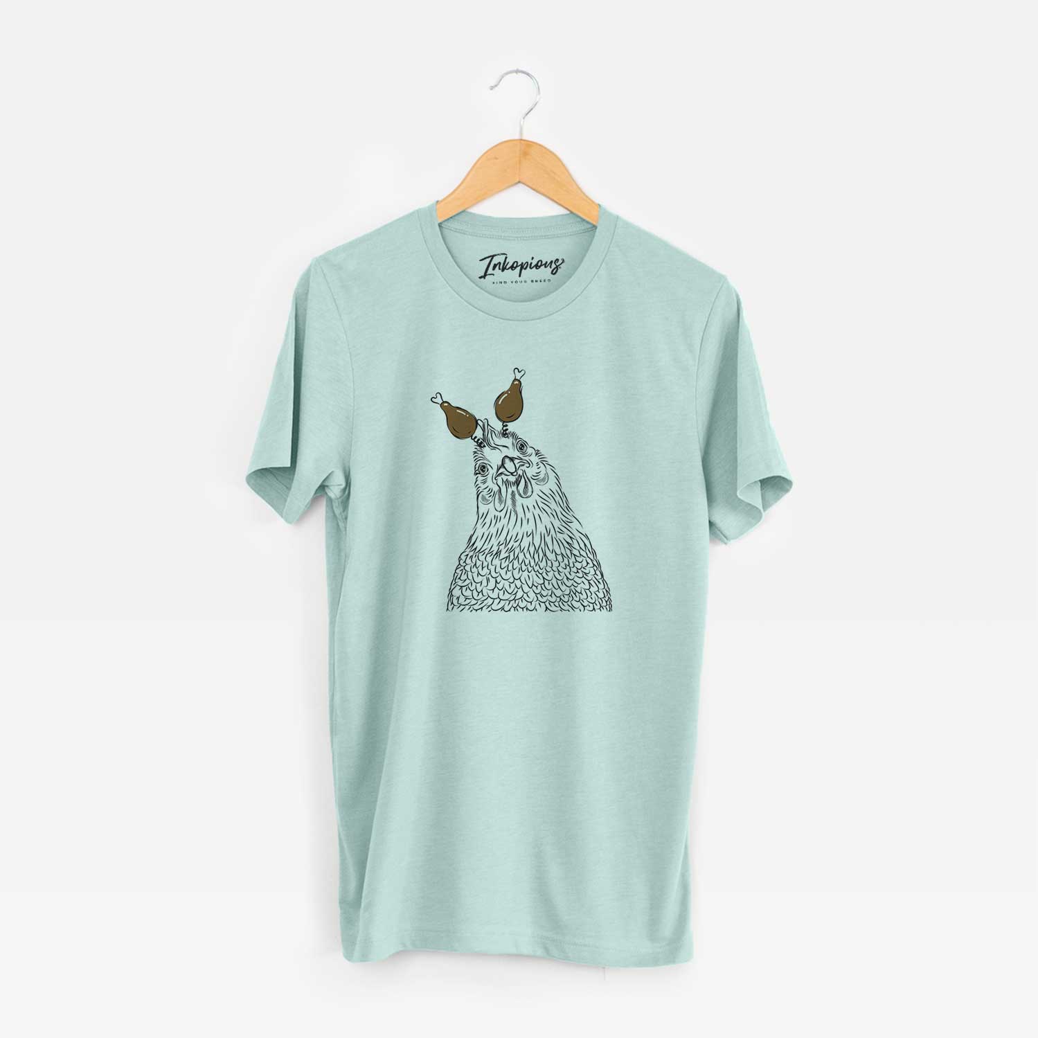 Hand-drawn sketch of Henrietta the Chicken with a Thanksgiving turkey headpiece on a Heather Sage Unisex crewneck