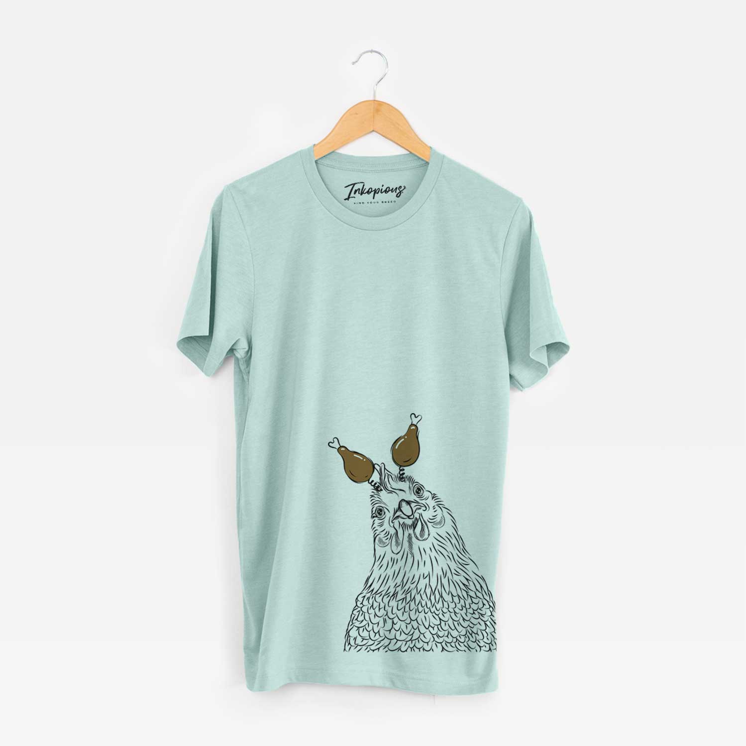 Hand-drawn sketch of Henrietta the Chicken with a Thanksgiving turkey headpiece on a Heather Sage Unisex crewneck