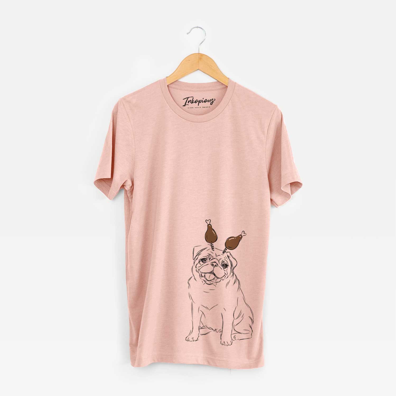 Hand-drawn sketch of Higgins the Pug with a Thanksgiving turkey headpiece on a Peach Unisex crewneck