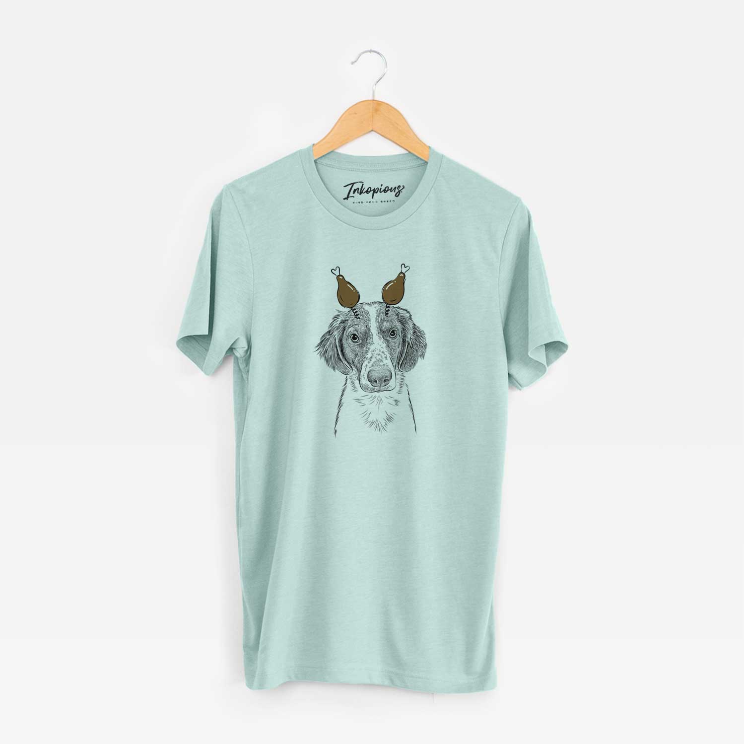 Hand-drawn sketch of Holly the Brittany Spaniel with a Thanksgiving turkey headpiece on a Heather Sage Unisex crewneck