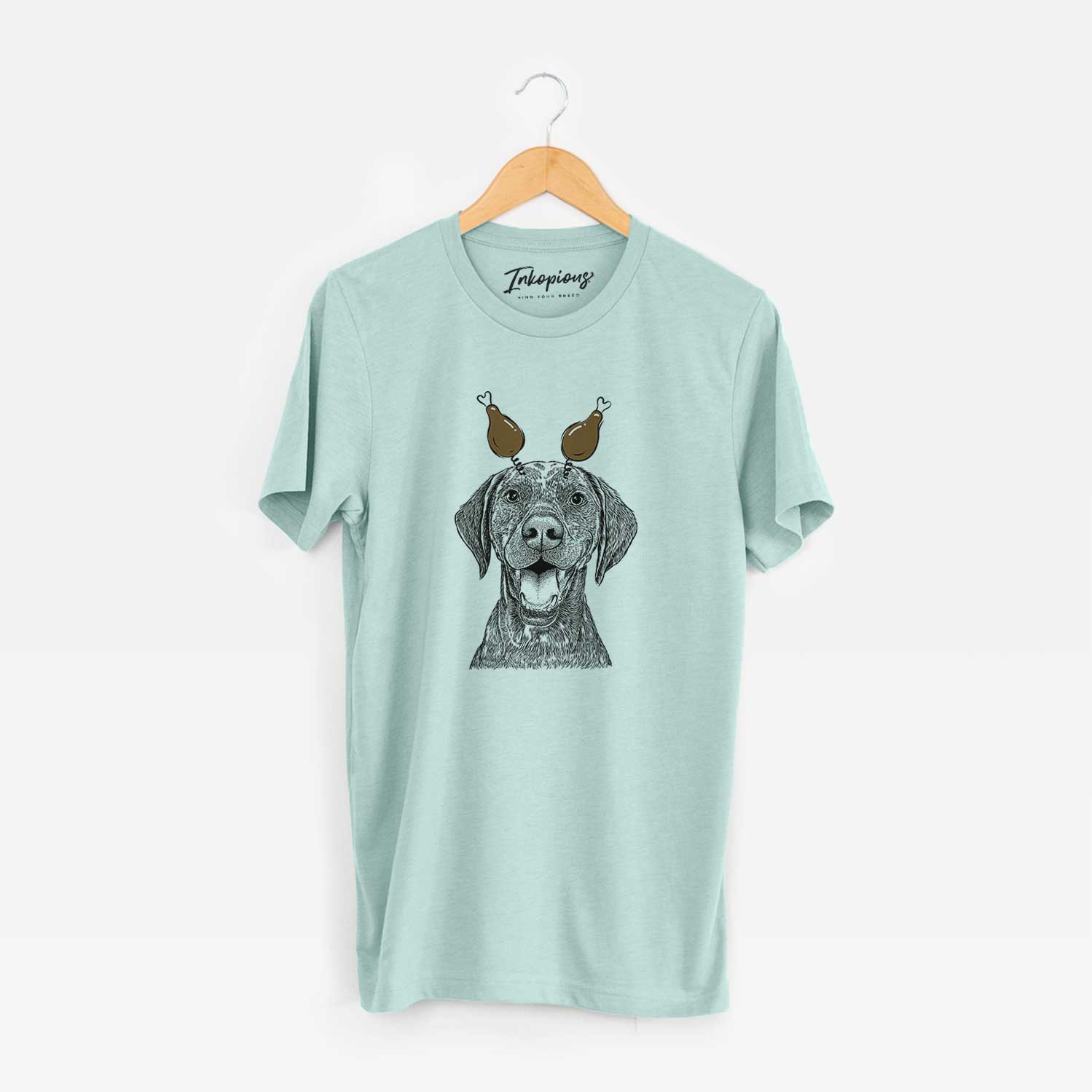 Hand-drawn sketch of Hudson the German Shorthaired Pointer with a Thanksgiving turkey headpiece on a Heather Sage Unisex crewneck