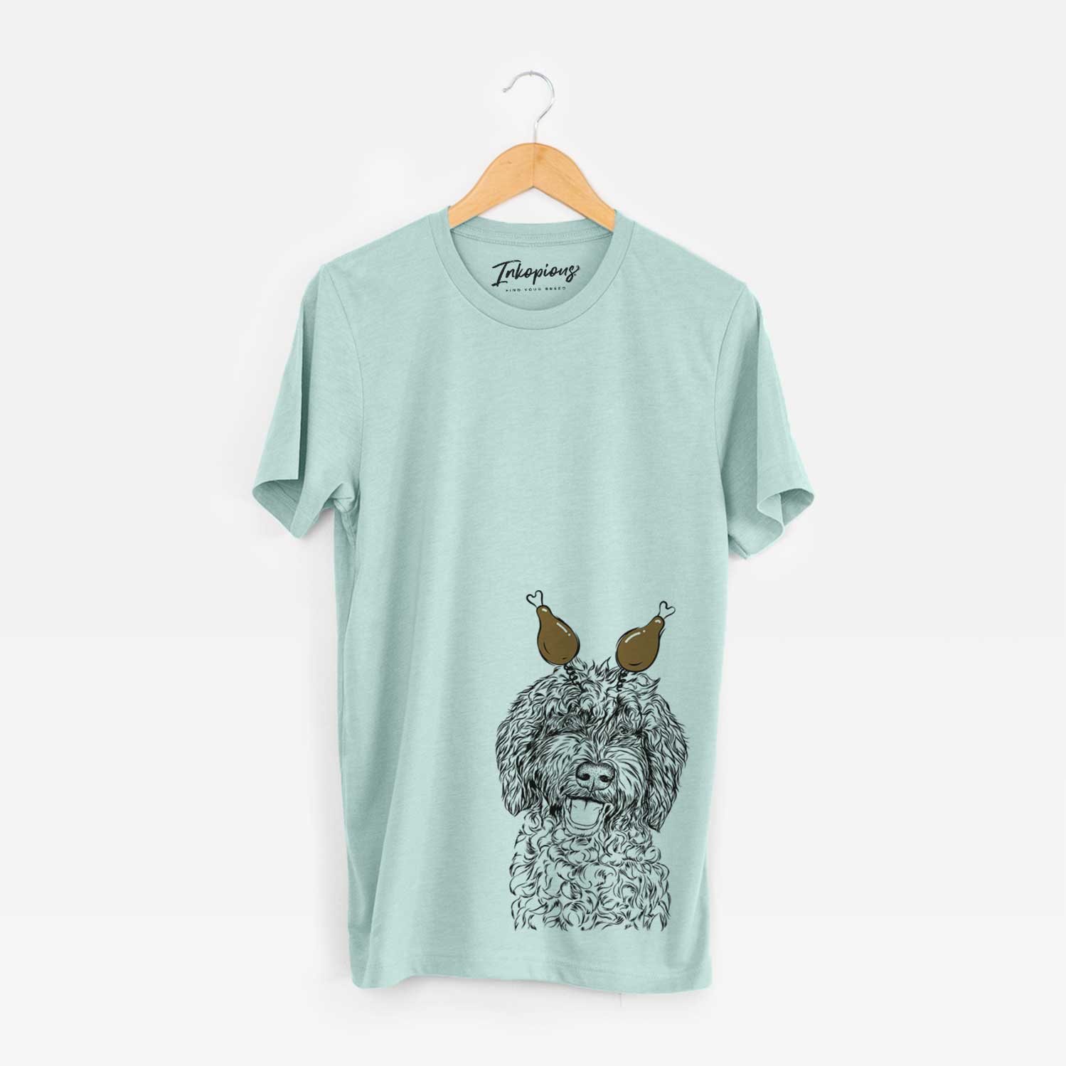 Hand-drawn sketch of Jack the Chocolate Labradoodle with a Thanksgiving turkey headpiece on a Heather Sage Unisex crewneck