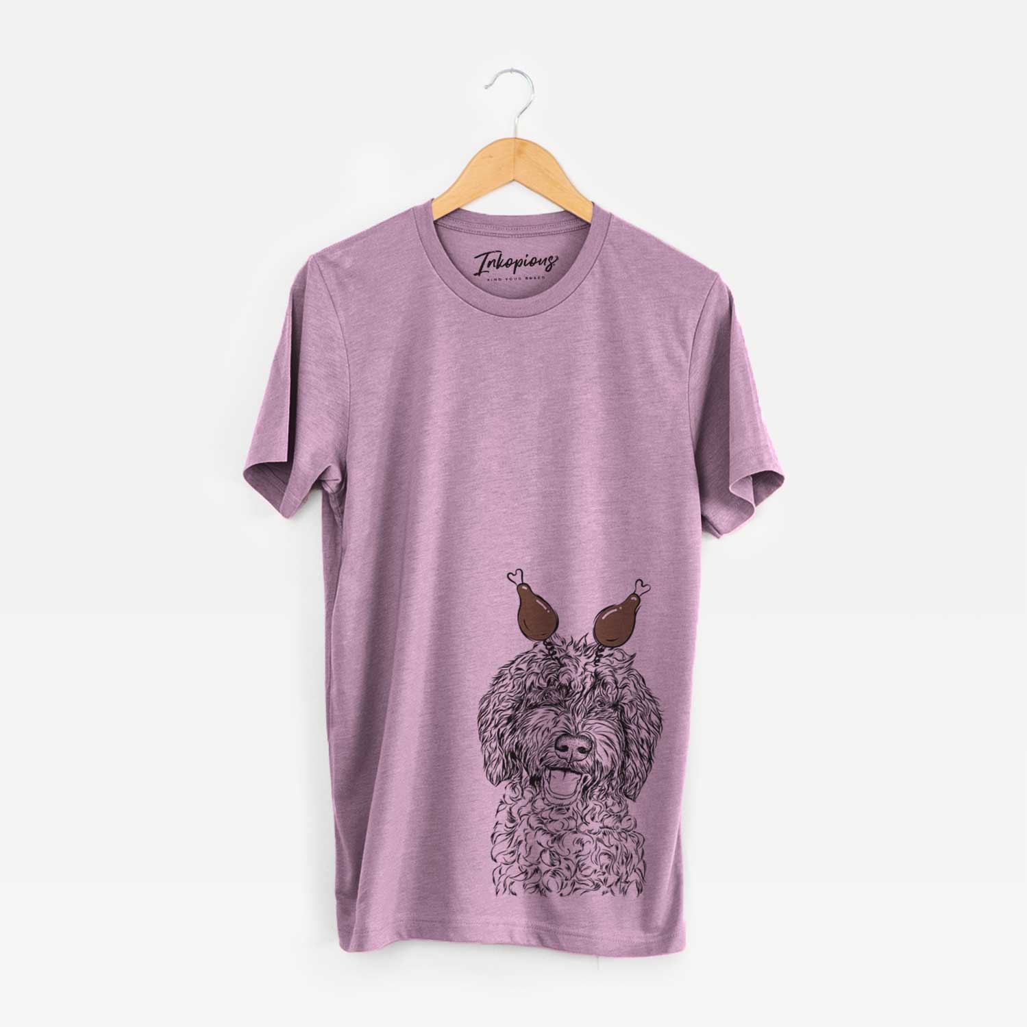 Hand-drawn sketch of Jack the Chocolate Labradoodle with a Thanksgiving turkey headpiece on an Orchid Unisex crewneck