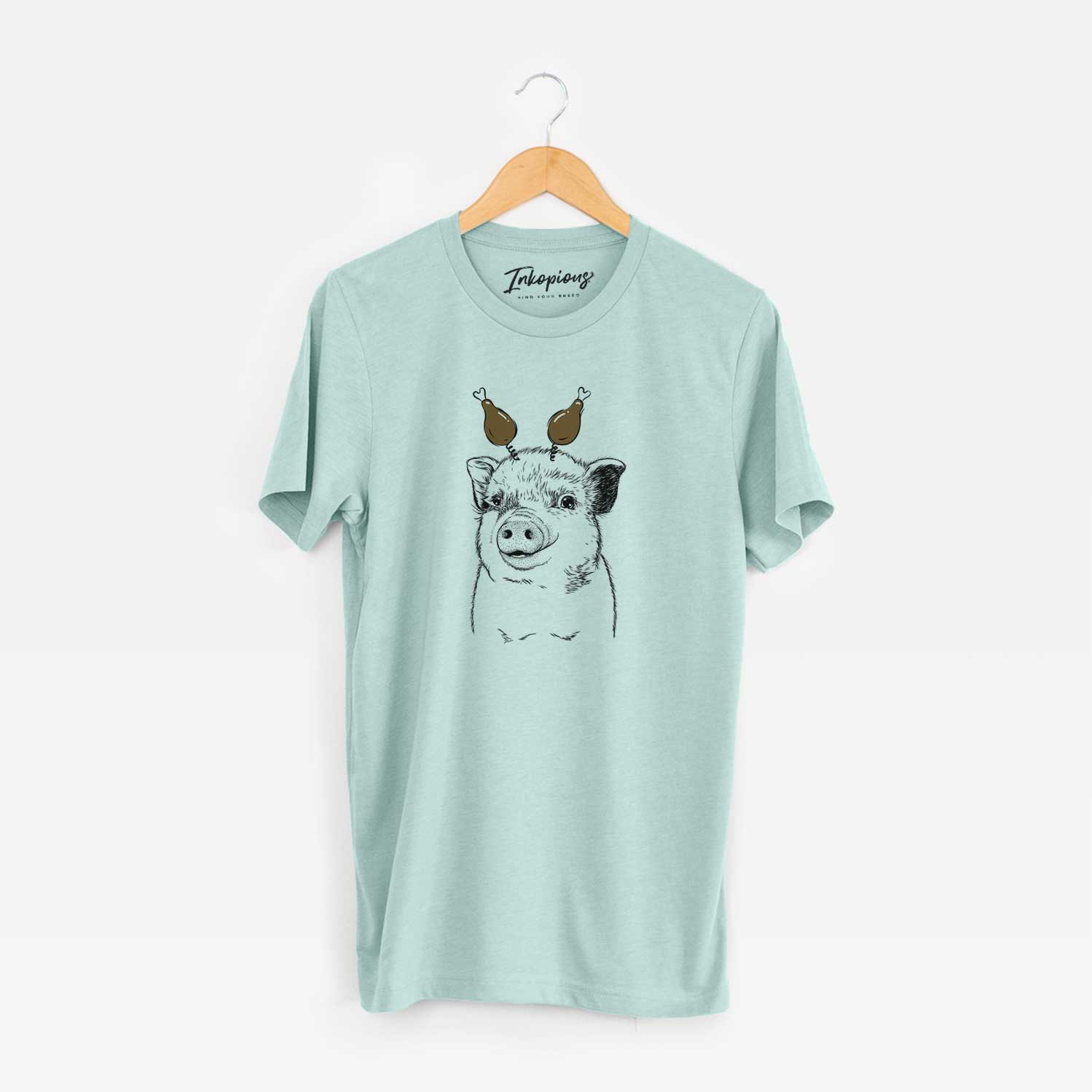 Hand-drawn sketch of Kevin the Spotted Pig with a Thanksgiving turkey headpiece on a Heather Sage Unisex crewneck