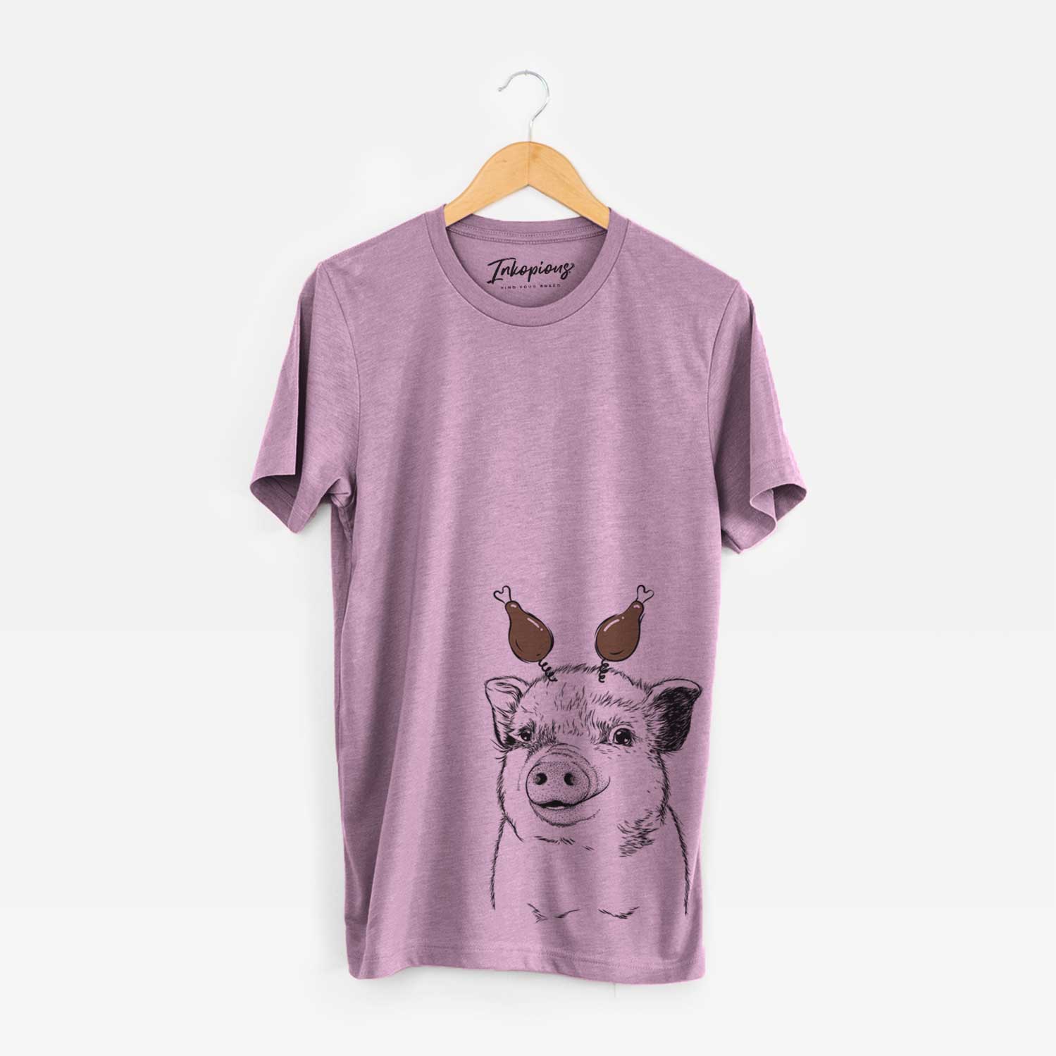 Hand-drawn sketch of Kevin the Spotted Pig with a Thanksgiving turkey headpiece on an Orchid Unisex crewneck