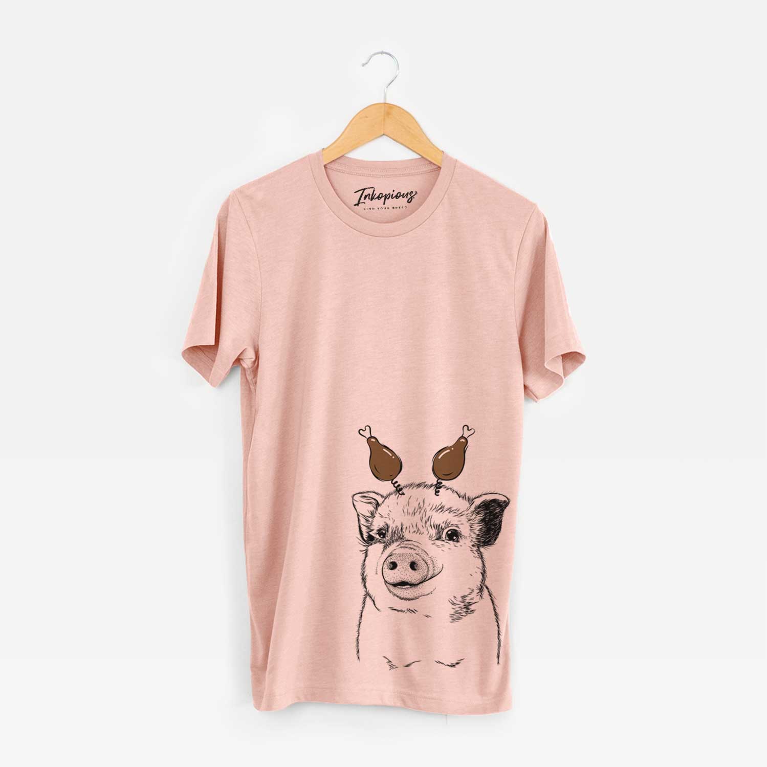 Hand-drawn sketch of Kevin the Spotted Pig with a Thanksgiving turkey headpiece on a Peach Unisex crewneck